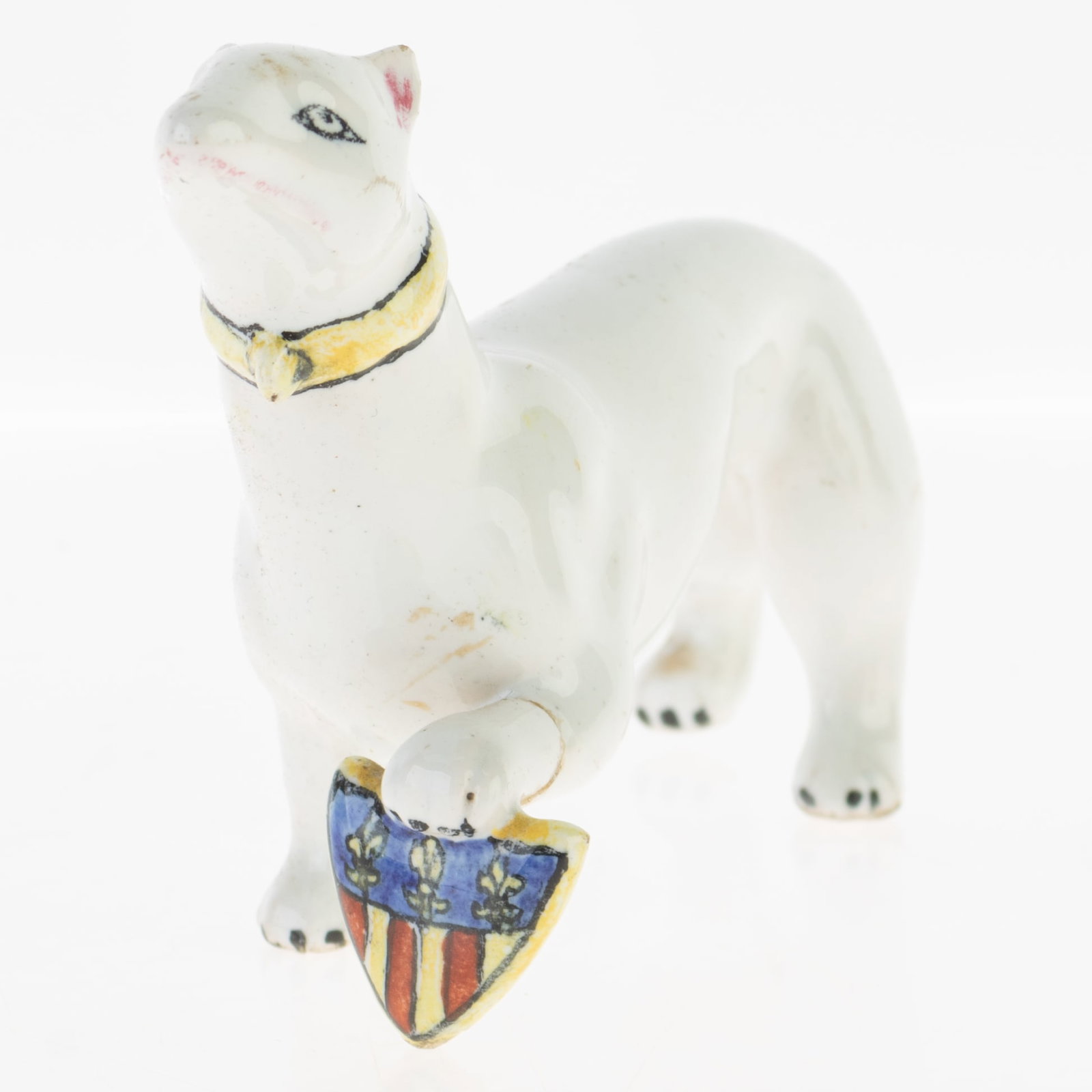 ANTIQUE CRESTWARE PORCELAIN DOG FIGURE WITH COAT OF ARMS: From a collection of Wedgwood and other selected ceramic/porcelain objects. Kindly examine all photographs provided in this listing or ask for a condition report. All items offered are in generally go