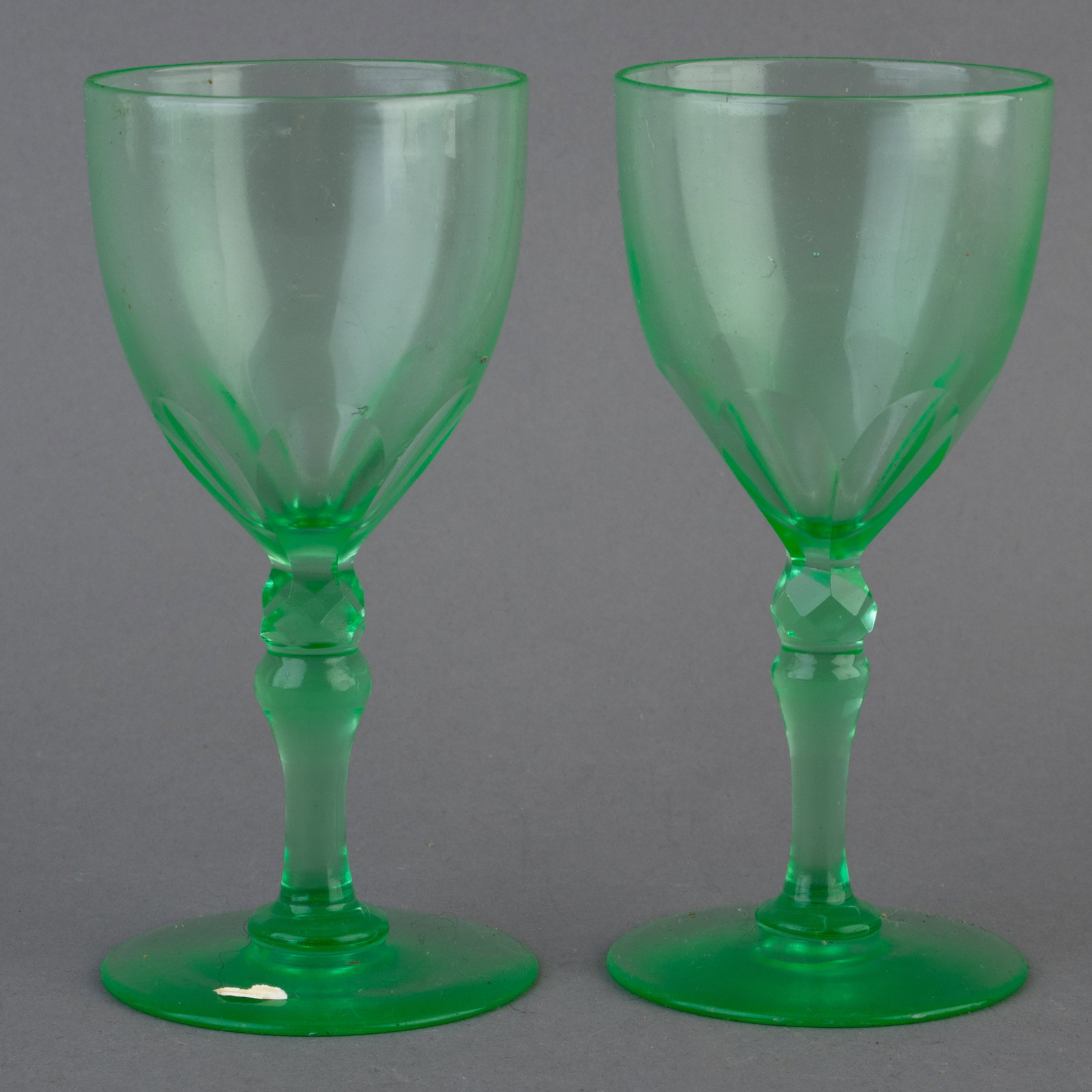 ANTIQUE PAIR OF URANIUM GREEN DRINKING GLASSES: From a collection of Wedgwood and other selected ceramic/porcelain objects. Kindly examine all photographs provided in this listing or ask for a condition report. All items offered are in generally go