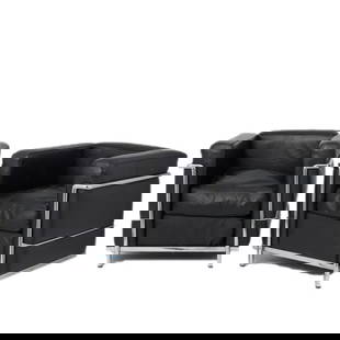 Pair Le Corbusier black leather / chrome lounge chairs: French 20th Century Mid Century Modern style.