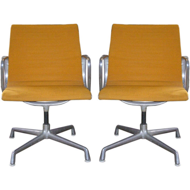 Aluminum Charles & Ray Eames Chair - Pair: A set of two aluminum chairs by Charles and Ray Eames from the 1950s, upholstered in original orange fabric. They are sold together as a set.