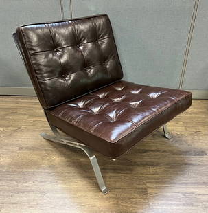 Brown Leather Lounge Chair: Vintage black tufted leather lounge chair.