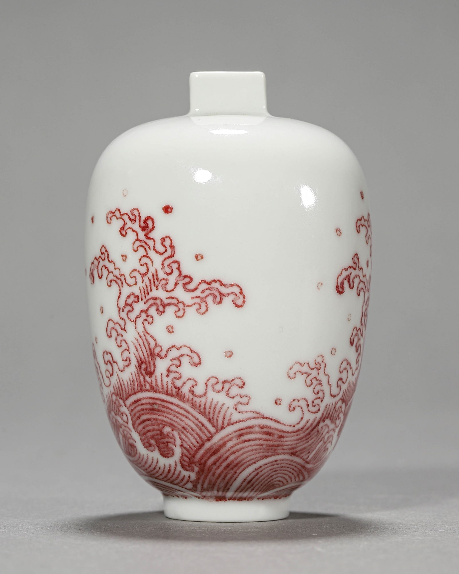 A Chinese snuff bottle with red underglaze sea water motif, Qing Dynasty, Yongzheng period. (1 of 7)