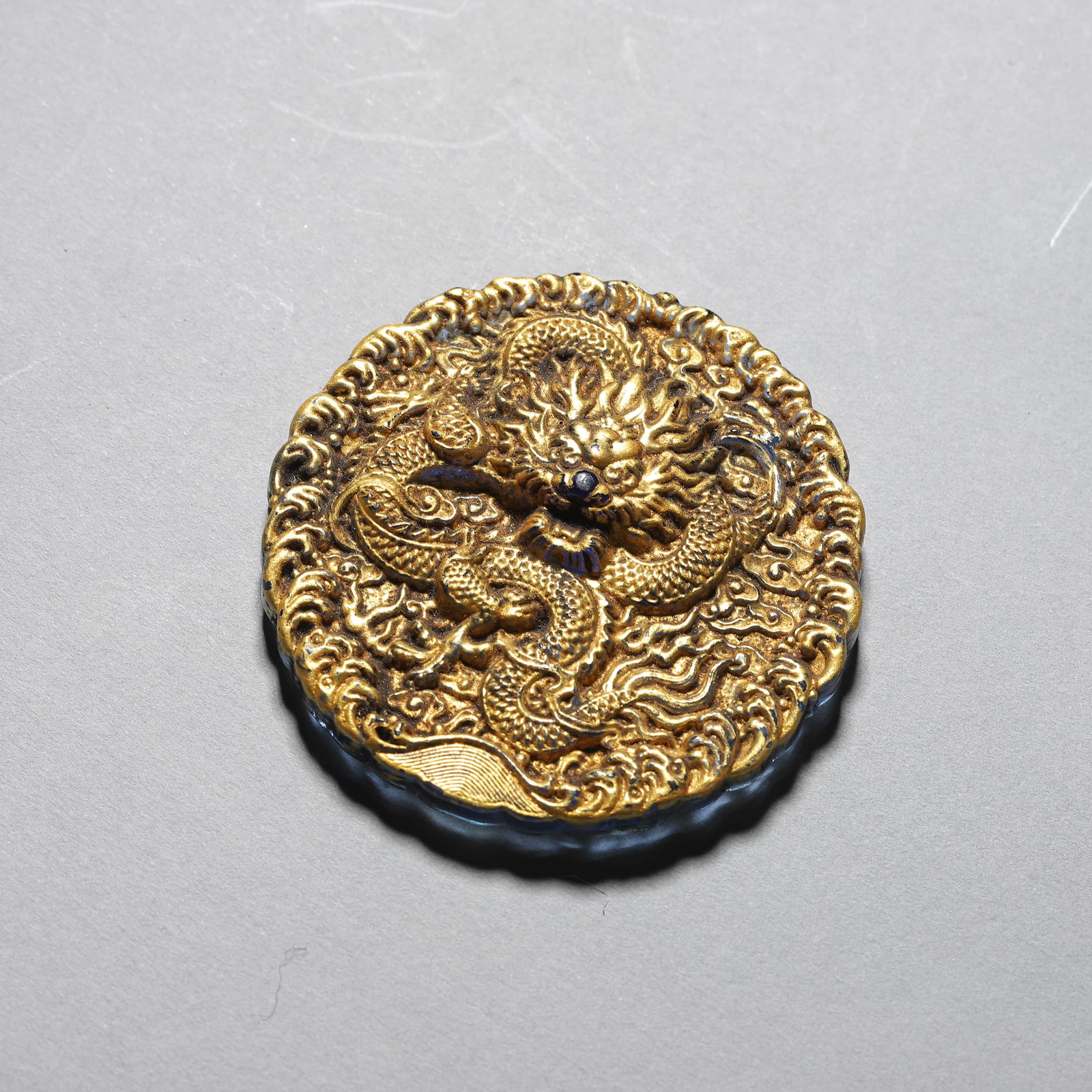 A CHINESE LACQUERED CLOUD DRAGON PATTERN TIBETAN PLATE. (1 of 2)