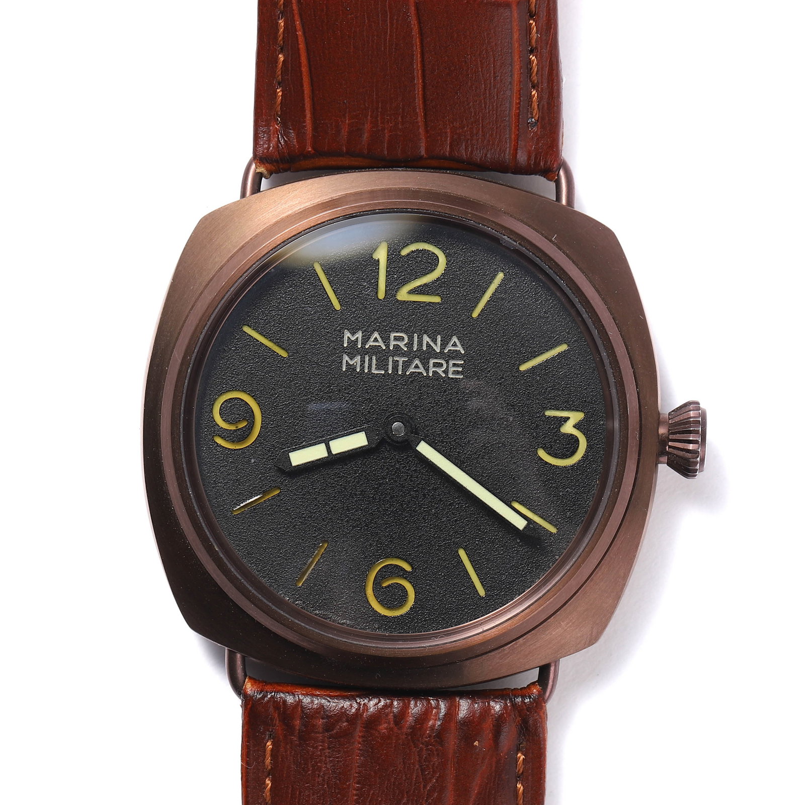 A MARINA MILITARE BRONZE CASE MECHANICAL WRISTWATCH: length: 24.5 in (62.2 cm); dial length: 1 3/4 in (4.5 cm) This Marina Militare wristwatch features a robust bronze case with a black sandwich dial, accented by luminous hands and hour markers. The bol