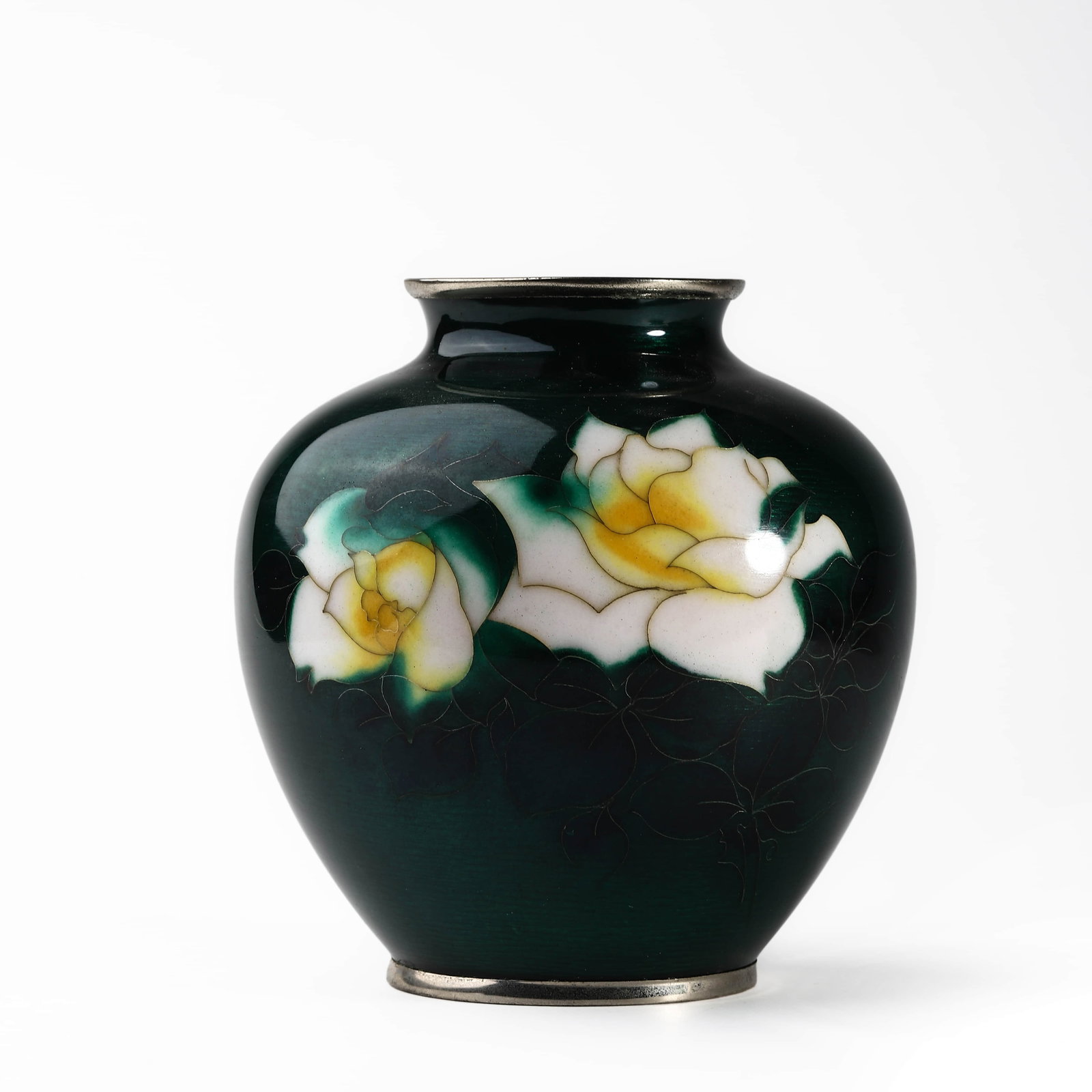 ENAMELED METAL VASE WITH WHITE AND YELLOW ROSE DECORATION: Dimensions: Height: 6 5/16 in. (16 cm) Description: A well-proportioned enameled metal vase with a deep green ground and silver-colored metal rims. The front features two fully bloomed roses in white 