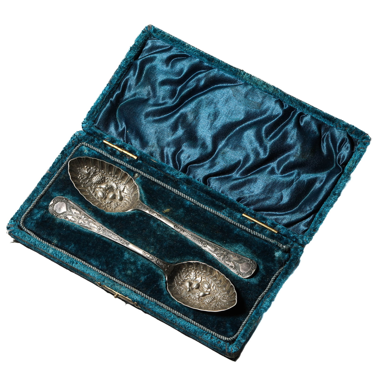A PAIR OF ENGLISH SILVER EMBOSSED SPOONS, 19TH CENTURY: Dimensions Each 6 1/2 in. (16.5 cm) long; Combined weight 70 g Description A pair of finely worked silver spoons, each with a richly embossed bowl decorated in high relief with fruit and floral motifs