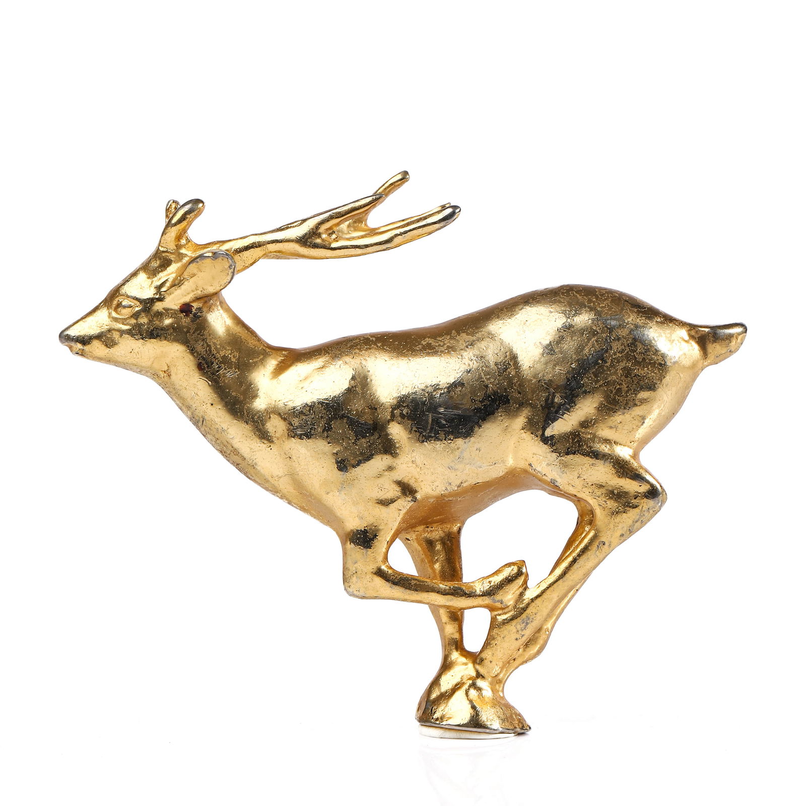 A GILT BRONZE FIGURE OF A RUNNING DEER: Dimensions Length: 5 5/16 in (13.5 cm); Height: 4 1/8 in (10.5 cm) Description: A charming gilt bronze figure depicting a deer captured in mid-stride, its body stretched forward with a sense of swift,