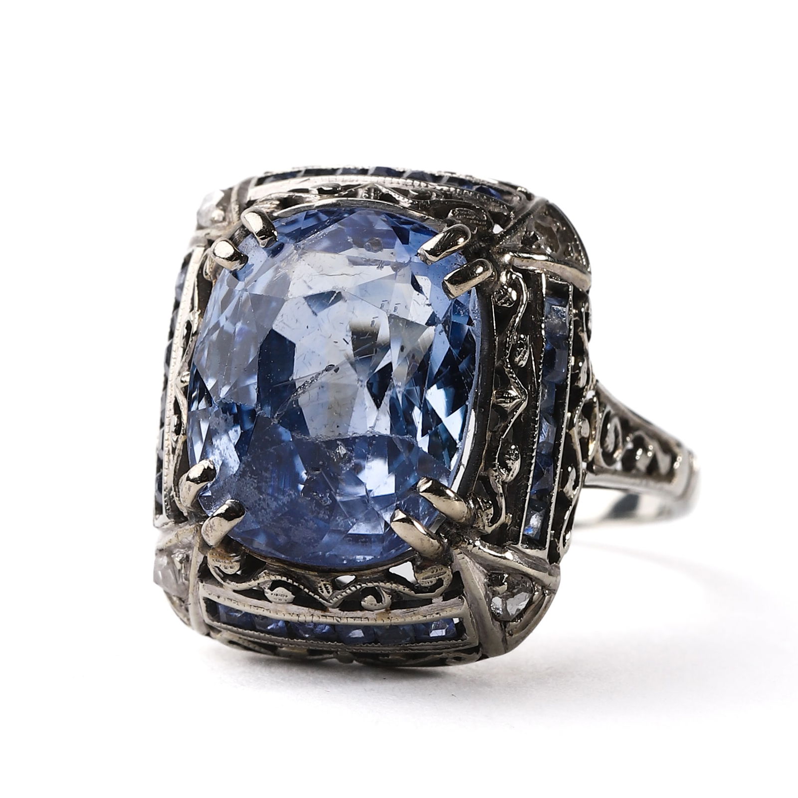 A PLATINUM RING SET WITH A NATURAL SAPPHIRE FROM SRI LANKA: Dimensions: Inner diam: 5/8 in. (16.2 mm); Total weight: 5.1 g Set with an oval modified brilliant-cut natural sapphire weighing 5.16 carats, measuring approximately 7/16 × 3/8 in. (11.76 × 9.28 mm)