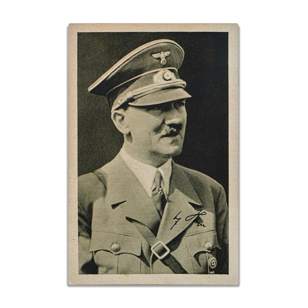 ADOLF HITLER SIGNED POSTCARD: 5 1/2 x 3 1/2 in (13.9 x 9 cm) This signed postcard presents a tightly composed historical artifact rooted in the visual and postal culture of its era. The portrait image, uniformed and formally stage