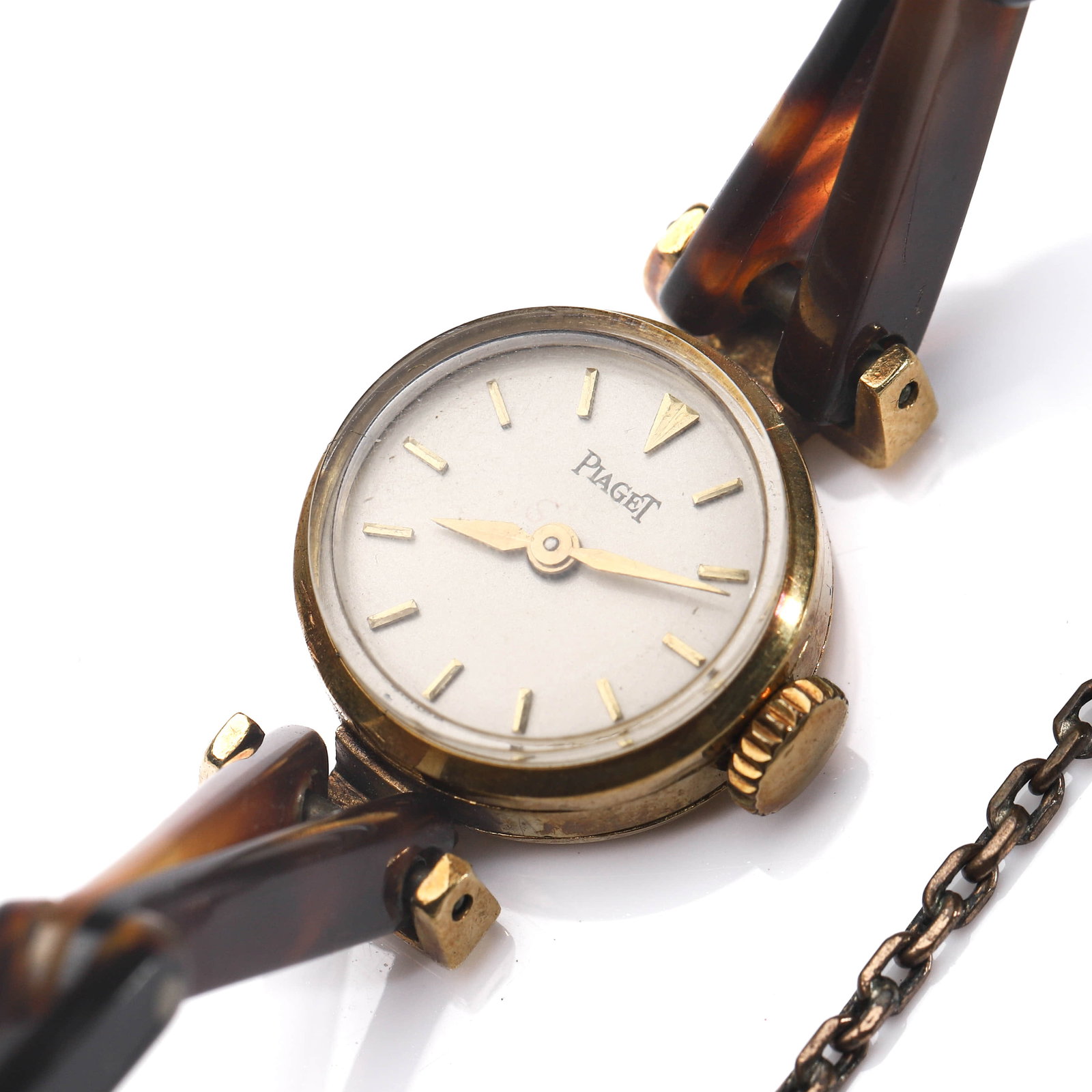 PIAGET LADY’S MANUAL-WIND WRISTWATCH: Dimensions Dial diameter: 21/32 in (17 mm) Description This elegant Piaget lady’s wristwatch features a compact round case with a minimalist silver-toned dial, applied baton hour markers, and slende