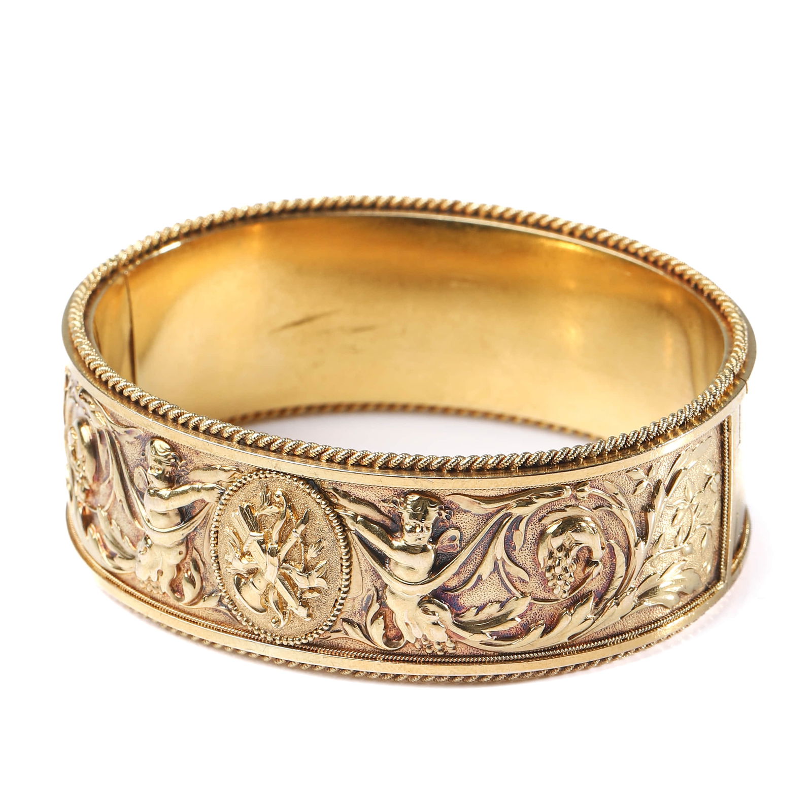 FRENCH ART NOUVEAU GOLD CUFF BRACELET WITH ANGEL AND CUPID MOTIF: Dimensions Inner diameter: approximately 2 to 2 5/16 in (51–59 mm); suitable for wrists up to approx. 6 1/2 in (16.5 cm).Weight: 65 g. Description A highly refined French Art Nouveau gold cuff brace