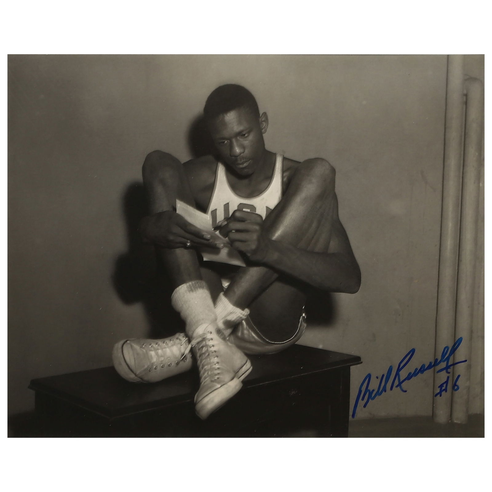 BILL RUSSELL, SIGNED BACKSTAGE PHOTOGRAPH, 1956 MELBOURNE OLYMPICS: Title BILL RUSSELL, SIGNED BACKSTAGE PHOTOGRAPH, 1956 MELBOURNE OLYMPICS Medium Gelatin silver photograph, mounted on board Signature Signed in blue marker, lower right Dimensions Photograph: 7