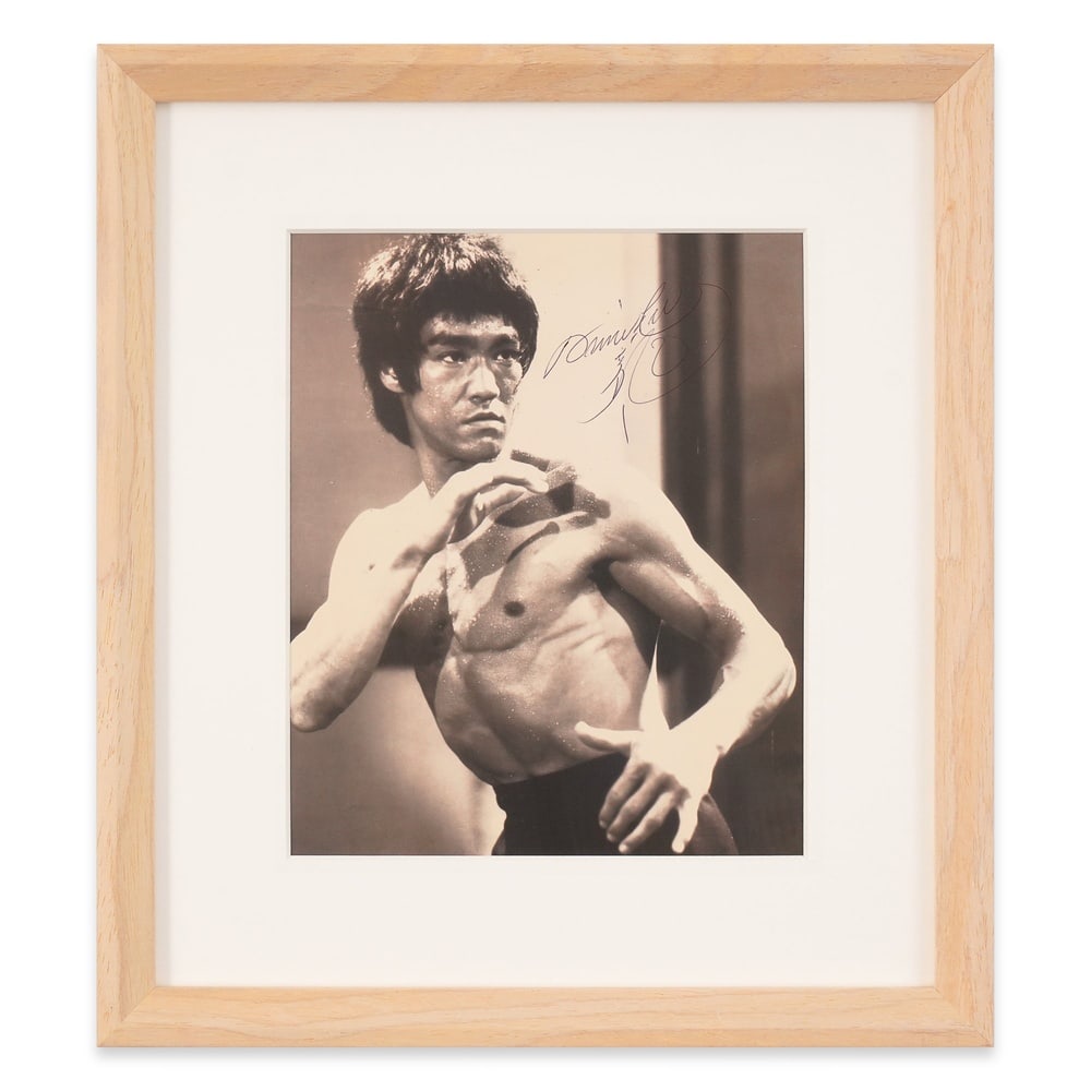 BRUCE LEE SIGNED PHOTOGRAPH: Photograph Dimensions: 8 5/8 x 7 1/8 in (22 x 18 cm) Framed Dimensions: 14 1/8 x 12 5/8 in (36 x 32 cm) Provenance and Authentication: This collectible has undergone a rigorous forensic evaluation.