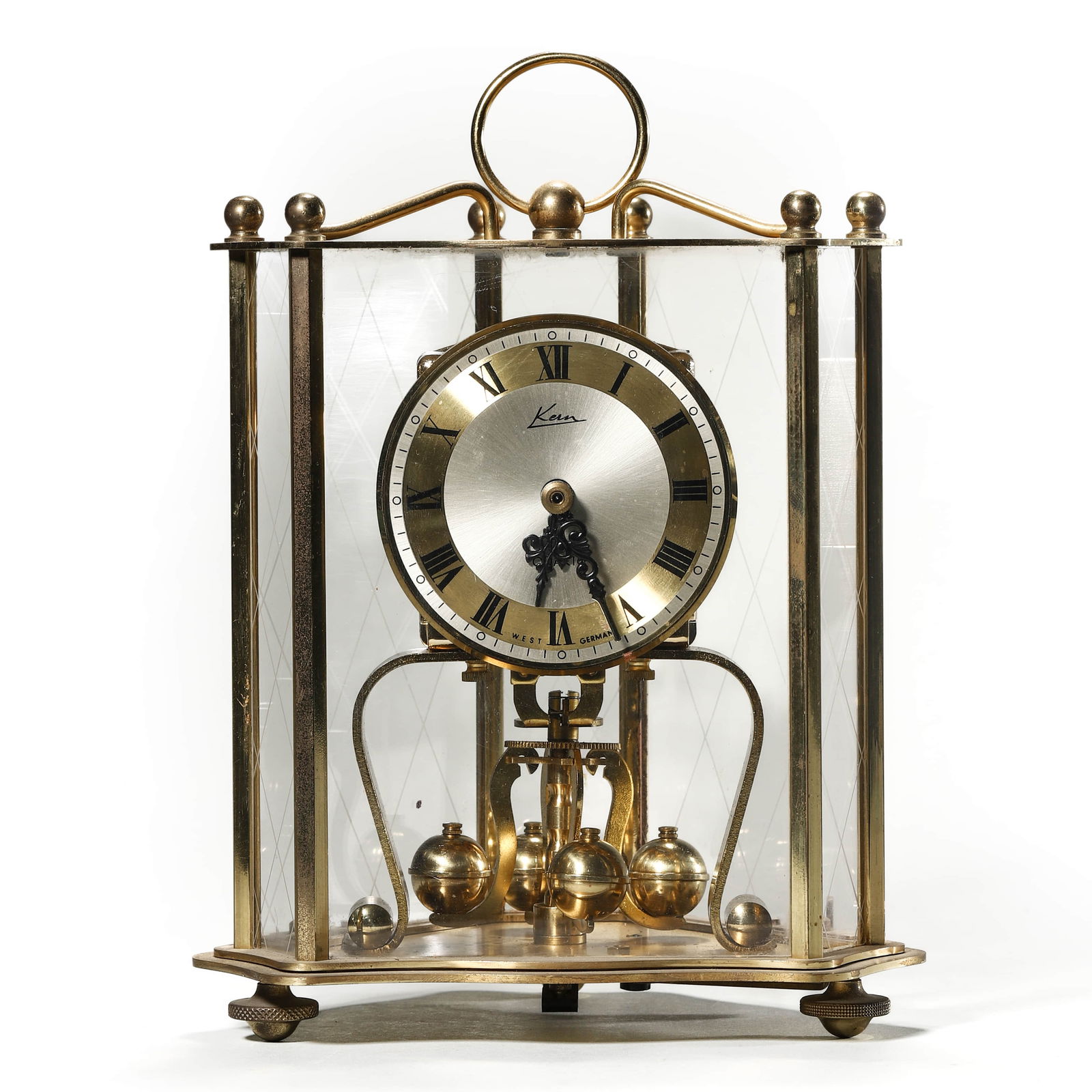 KERN & SÖHNE GERMAN ANNIVERSARY CLOCK: Dimensions: Length: 5 7/8 in. (15 cm), Height: 8 1/2 in. (21.5 cm). Description: A German quartz anniversary clock by Kern & Söhne, featuring a brass frame with beveled glass panels and a polished