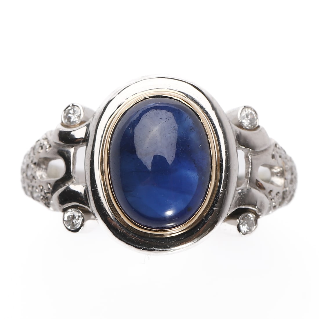 A SAPPHIRE AND DIAMOND RING, PLATINUM AND GOLD MOUNT: Dimensions Inner diameter 0.67 in (17 mm); Sapphire 0.38 × 0.27 in (9.7 × 6.8 mm); Weight 7.2 g Description A platinum ring (marked Pt900) with yellow gold bezel, centering an oval cabochon