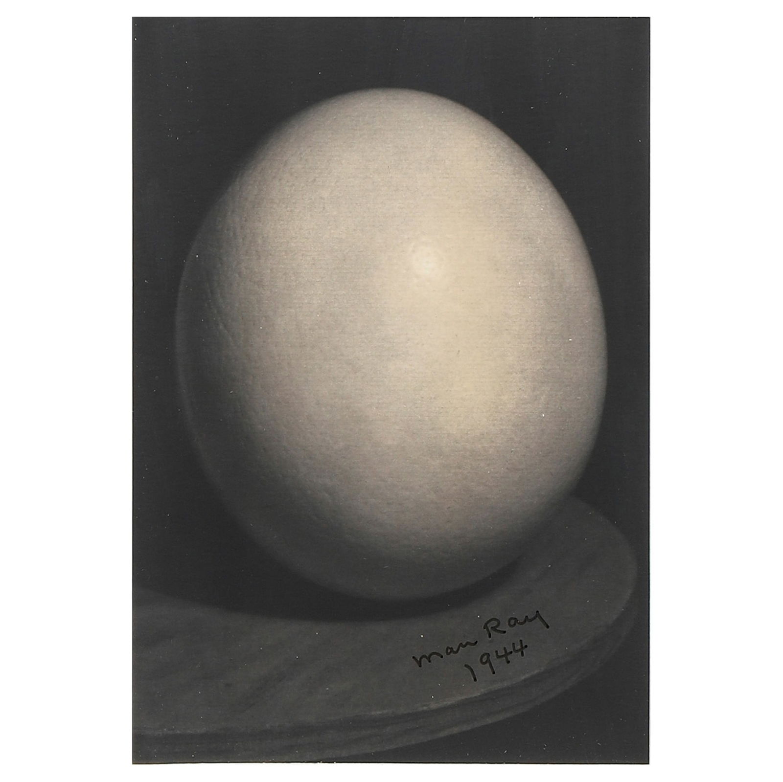 MAN RAY (1890–1976)OSTRICH EGG: Description Artist MAN RAY (1890–1976) Title OSTRICH EGG Medium Silver gelatin photograph, mounted on board Signature Signed in black ink at the lower right on the front Dimensions Photograph: