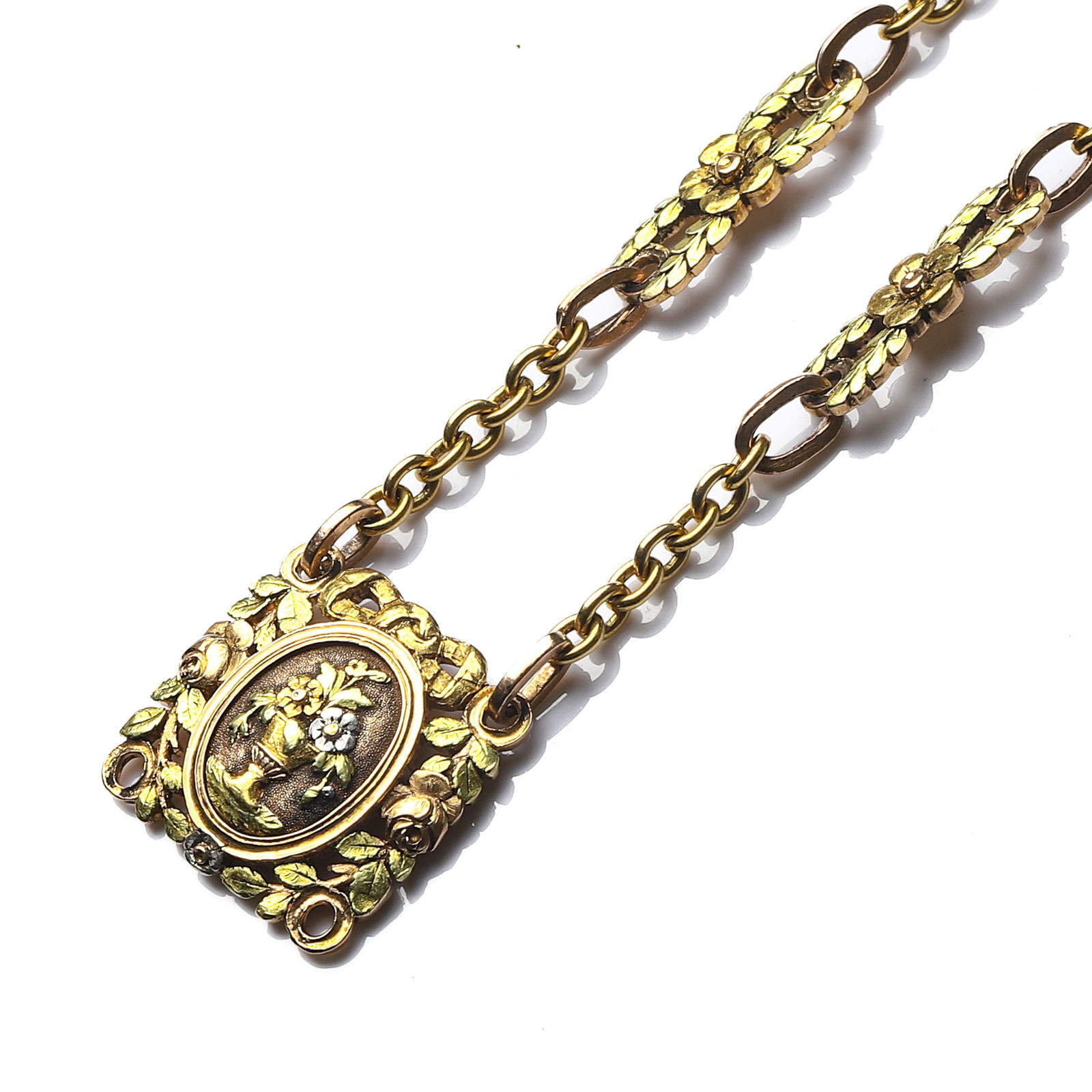 ANTIQUE GOLD LOCKET NECKLACE WITH FLORAL MOTIF: DimensionsLength: 12 5/8 in. (32 cm); Weight: 26.6 g Description An elegant antique gold necklace featuring a decorative floral-link chain and a central rectangular locket pendant with an oval