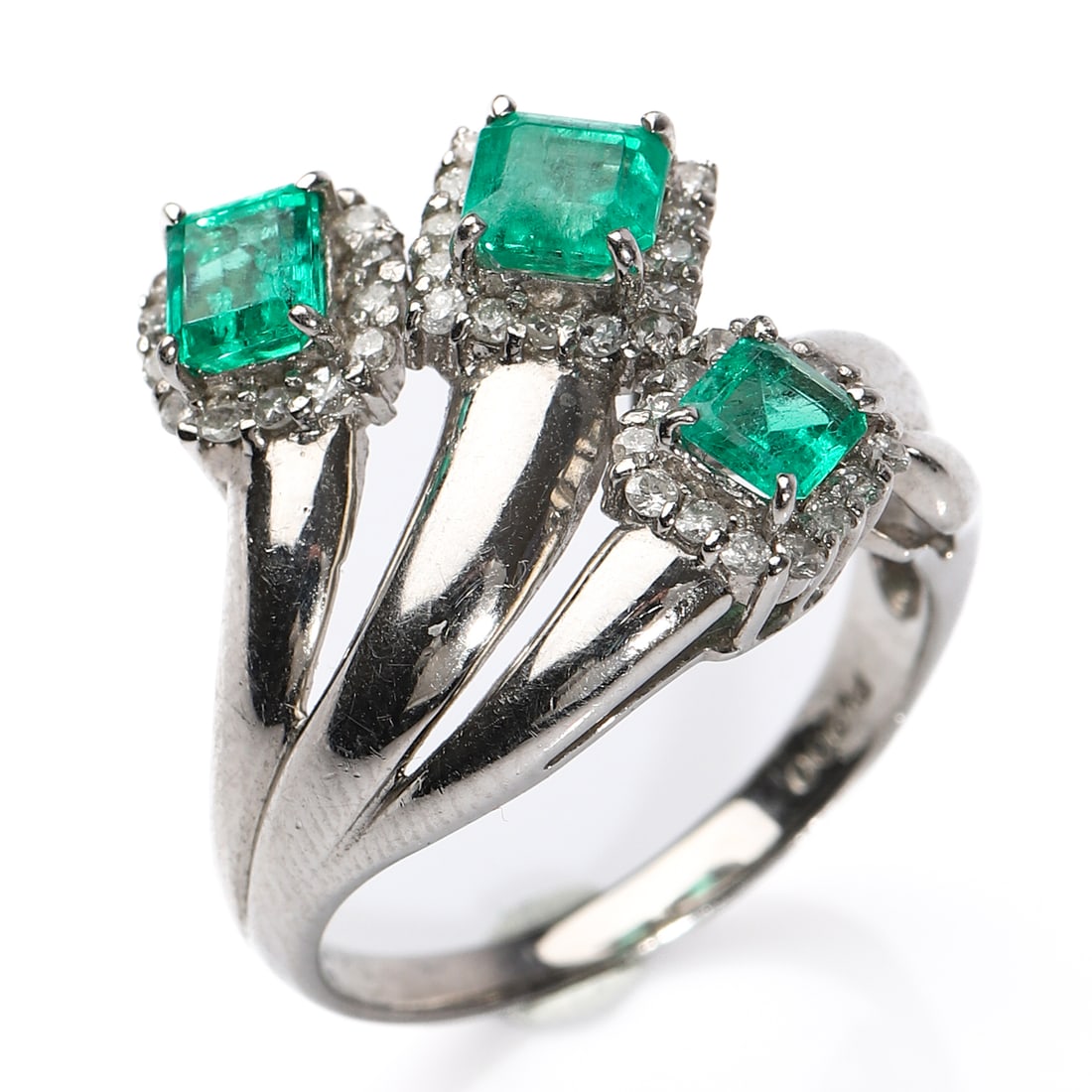 PLATINUM EMERALD AND DIAMOND RING, RETRO PERIOD: Dimensions Inner diameter: 11/16 in (17 mm); Weight: 7.7 g Description A Retro period platinum ring set with three square-cut emeralds totaling 1.03 carats, each framed by small round brilliant-cut