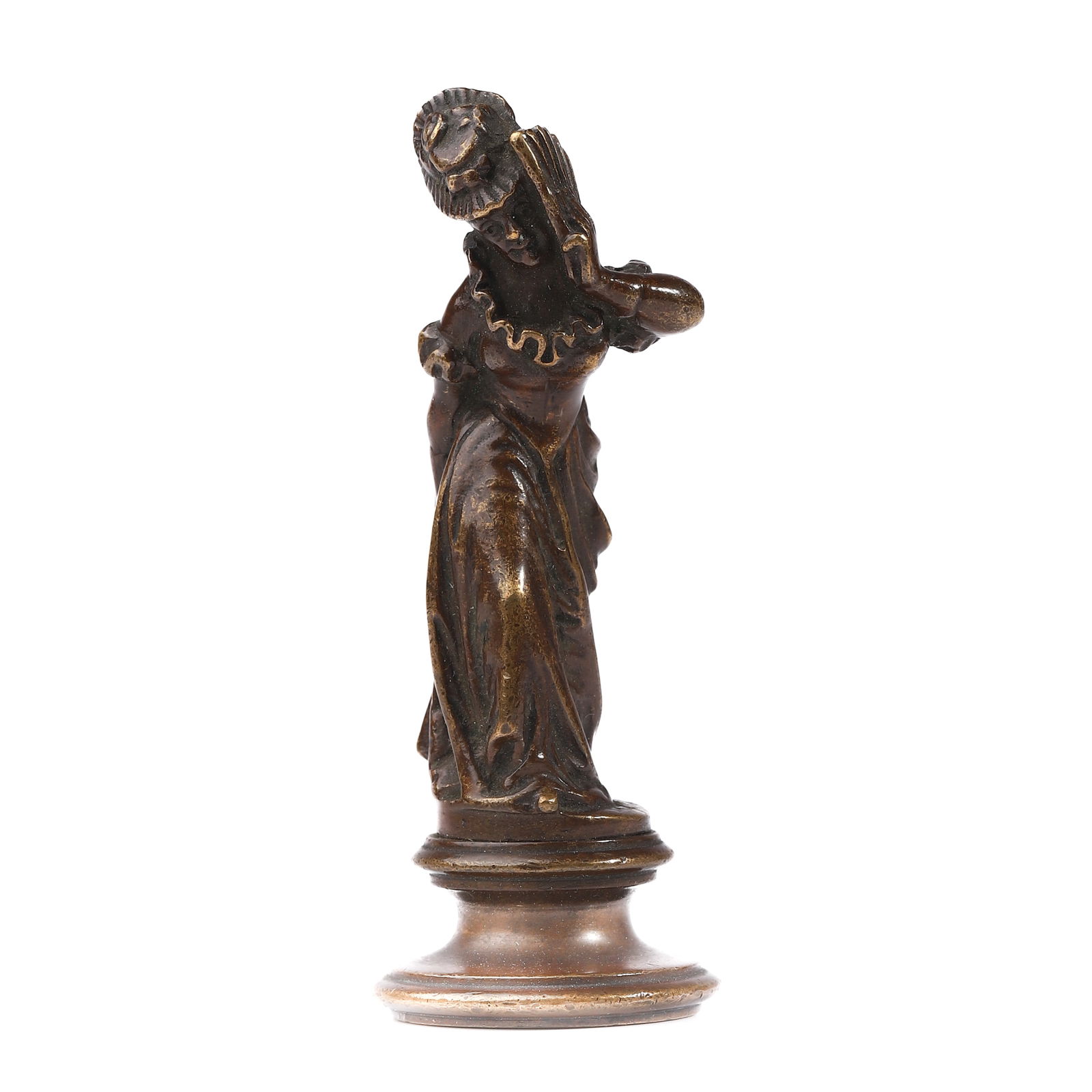A BRONZE FIGURAL SEAL OF A LADY: Dimensions Height 3 1/8 in (8 cm); Weight 134.8 g. Description A bronze seal modeled as a graceful lady in flowing drapery, captured in a dynamic pose with one hand raised toward her face. The