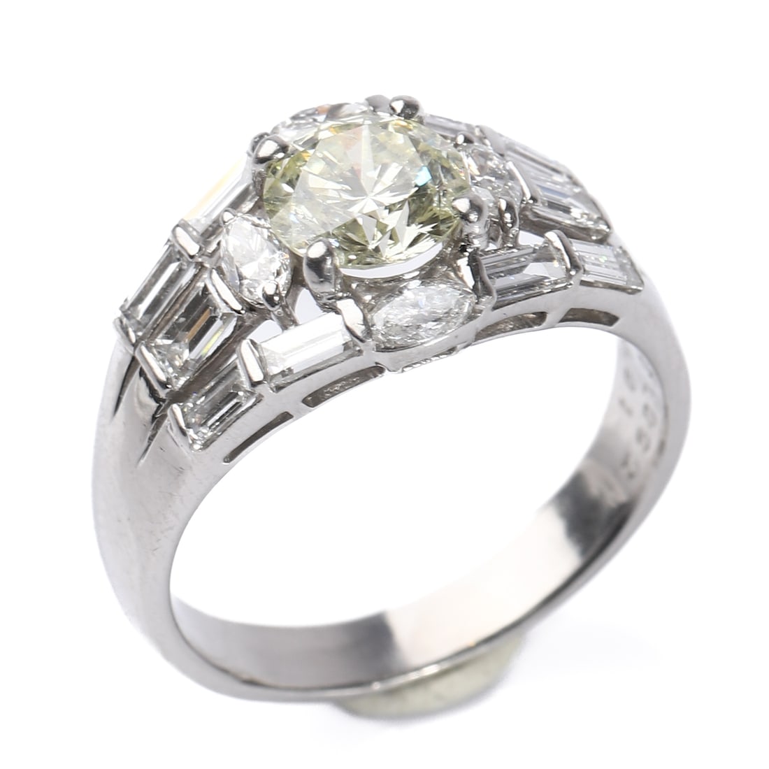 YELLOW DIAMOND RING: Dimensions: Inner diameter: 17 mm (? 11/16 in); Weight: 6.7 g Description & Analysis This platinum ring (Pt900) features a brilliant yellow round-cut diamond at the center, complemented by an arrangem