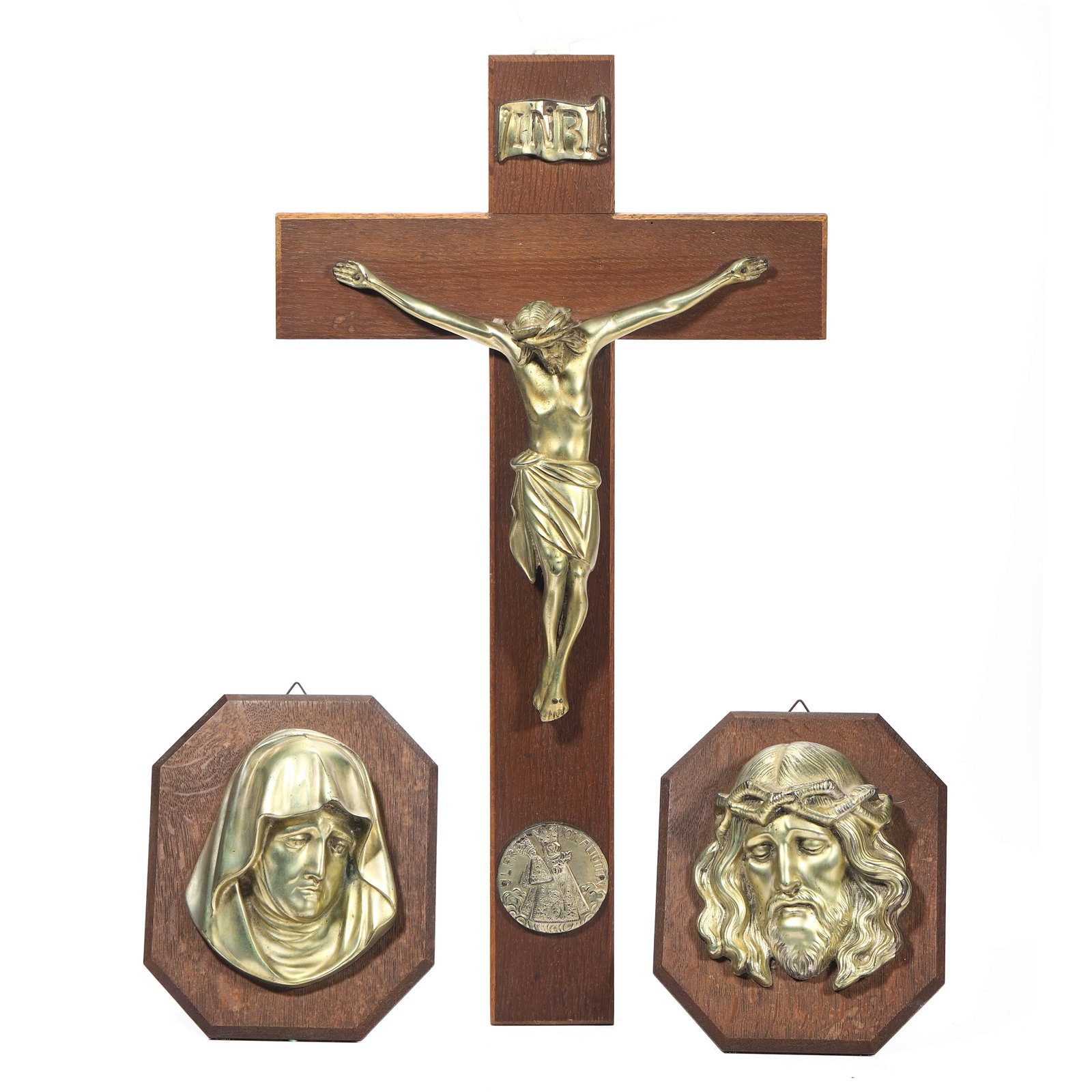 GERMAN, EARLY TO MID-20TH CENTURY — A WOODEN CRUCIFIX WITH BRASS RELIEF PLAQUES.: Cross: 19 3/4 × 11 in. (50 × 28 cm); Relief plaques: 7 1/16 × 5 7/8 in. (18 × 15 cm). Description: A devotional wall crucifix featuring a carved corpus of Christ in ivory-toned resin mounted on a