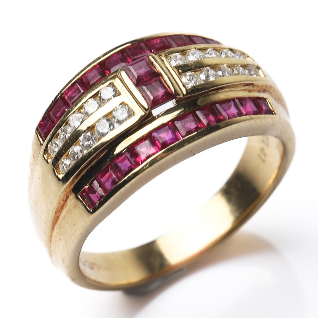 18K GOLD RUBY AND DIAMOND BAND RING: Dimensions Inner diameter: 23/32 in (18.4 mm); Weight: 8.5 g Description This substantial band ring is crafted in 18k yellow gold and designed with three horizontal rows of channel-set square-cut rubi