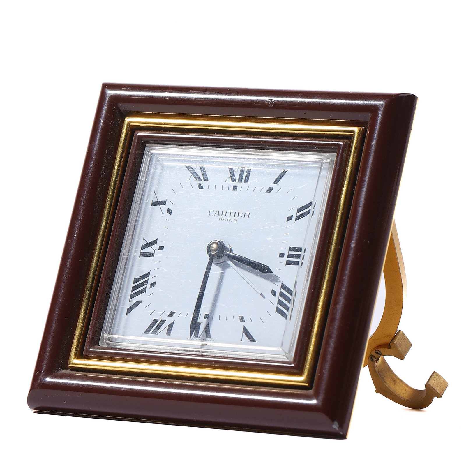 CARTIER PARIS QUARTZ DESK CLOCK: length: 2 15/16 in (7.5 cm); width: 2 15/16 in (7.5 cm) A Cartier Paris quartz desk clock, featuring a square frame with Roman numeral hour markers and a white enamel dial. The timepiece is housed in