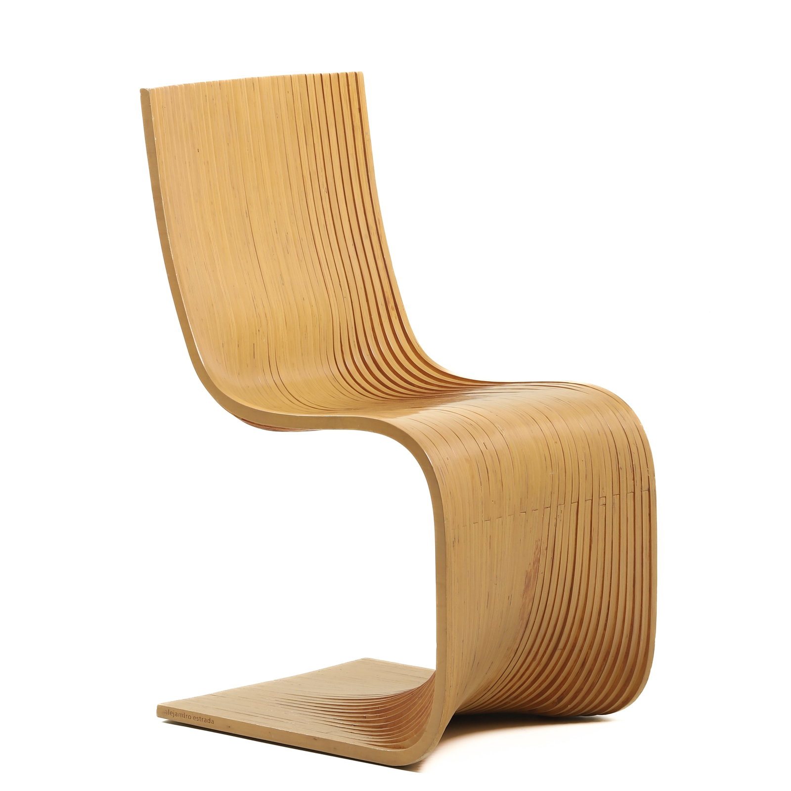 ALEJANDRO ESTRADA "PILLOW" CHAIR: Dimensions 15 3/4 × 16 7/8 × 35 7/16 in (40 × 43 × 90 cm) Description A sculptural "Pillow" chair by Alejandro Estrada, composed of multiple laminated wood slats forming a continuous S-shaped