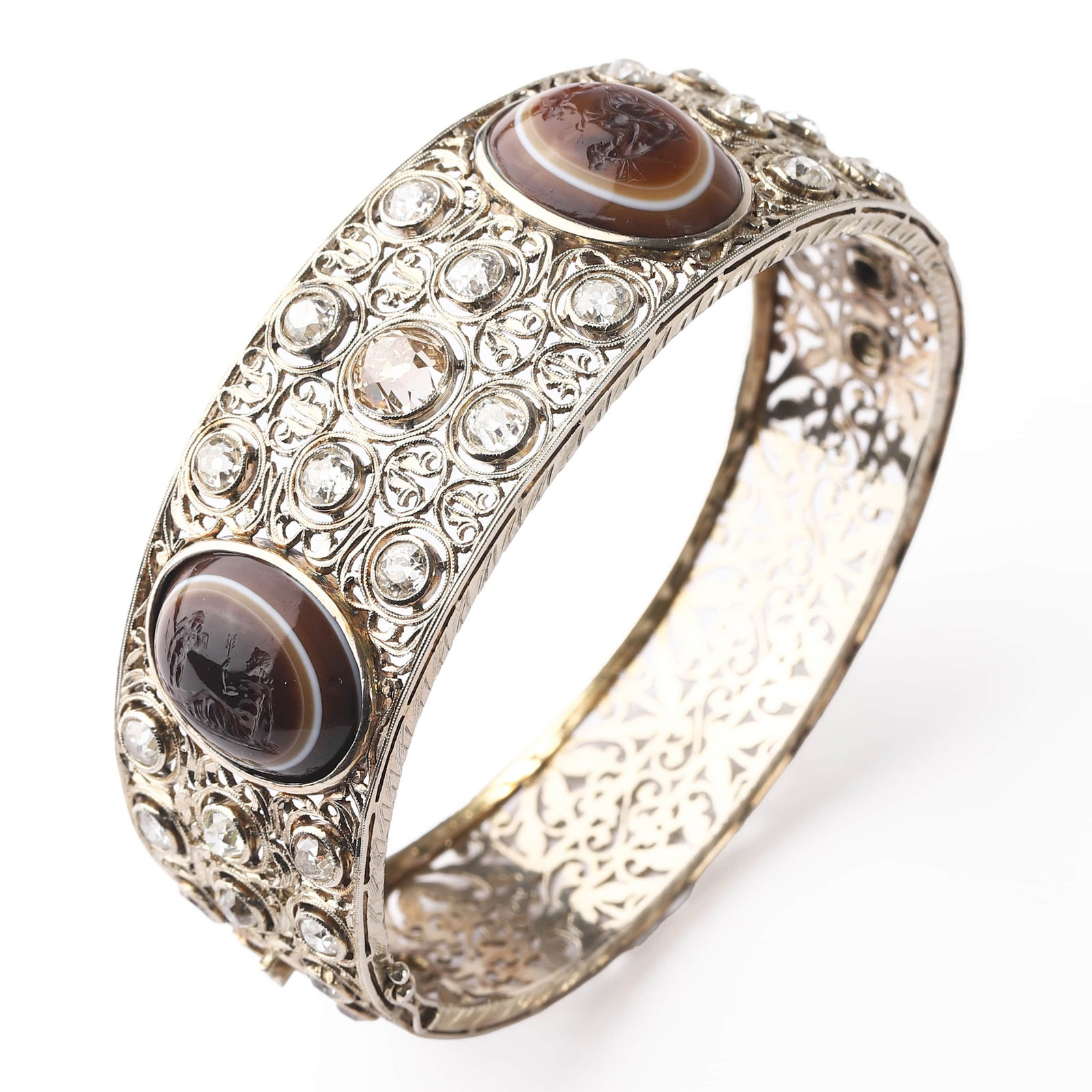 EDWARDIAN STYLE FILIGREE DIAMOND AND AGATE CAMEO BANGLE.: Dimensions: Inner Diameter: 2 1/2 in. (64.4 mm), Weight: 45.2 g This ornate bangle is exquisitely crafted in a delicate filigree design, featuring two large oval banded agate cameos intricately