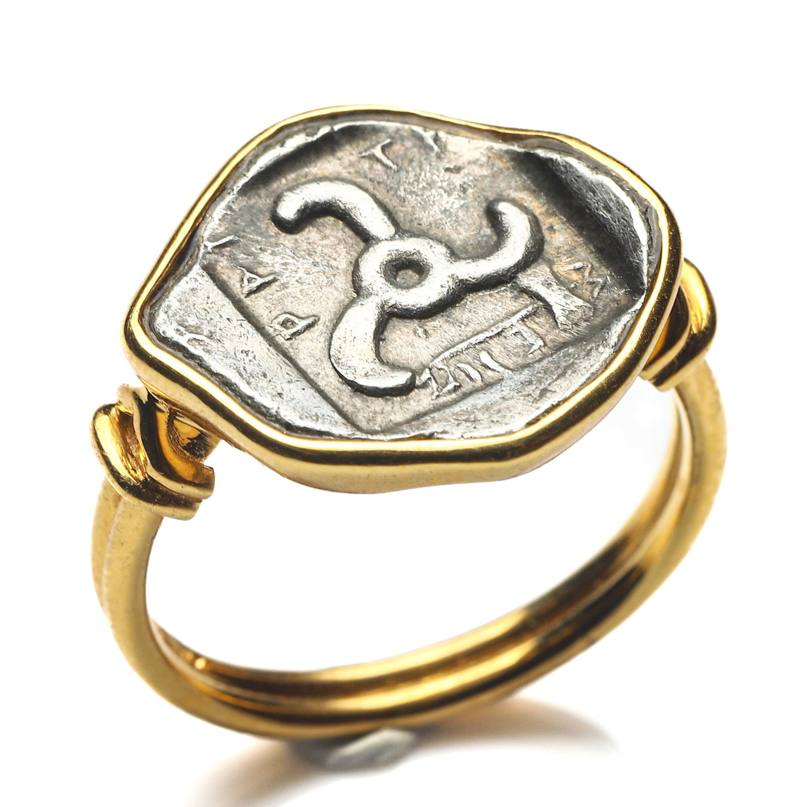 ANCIENT GREEK TRISKELES COIN 18K GOLD RING: Dimensions Ring Size HK 14 Weight 5.0 g Description An 18K gold ring set with an antique silver coin featuring the Triskeles, one of the most enduring symbols of the ancient Greek world. The coin
