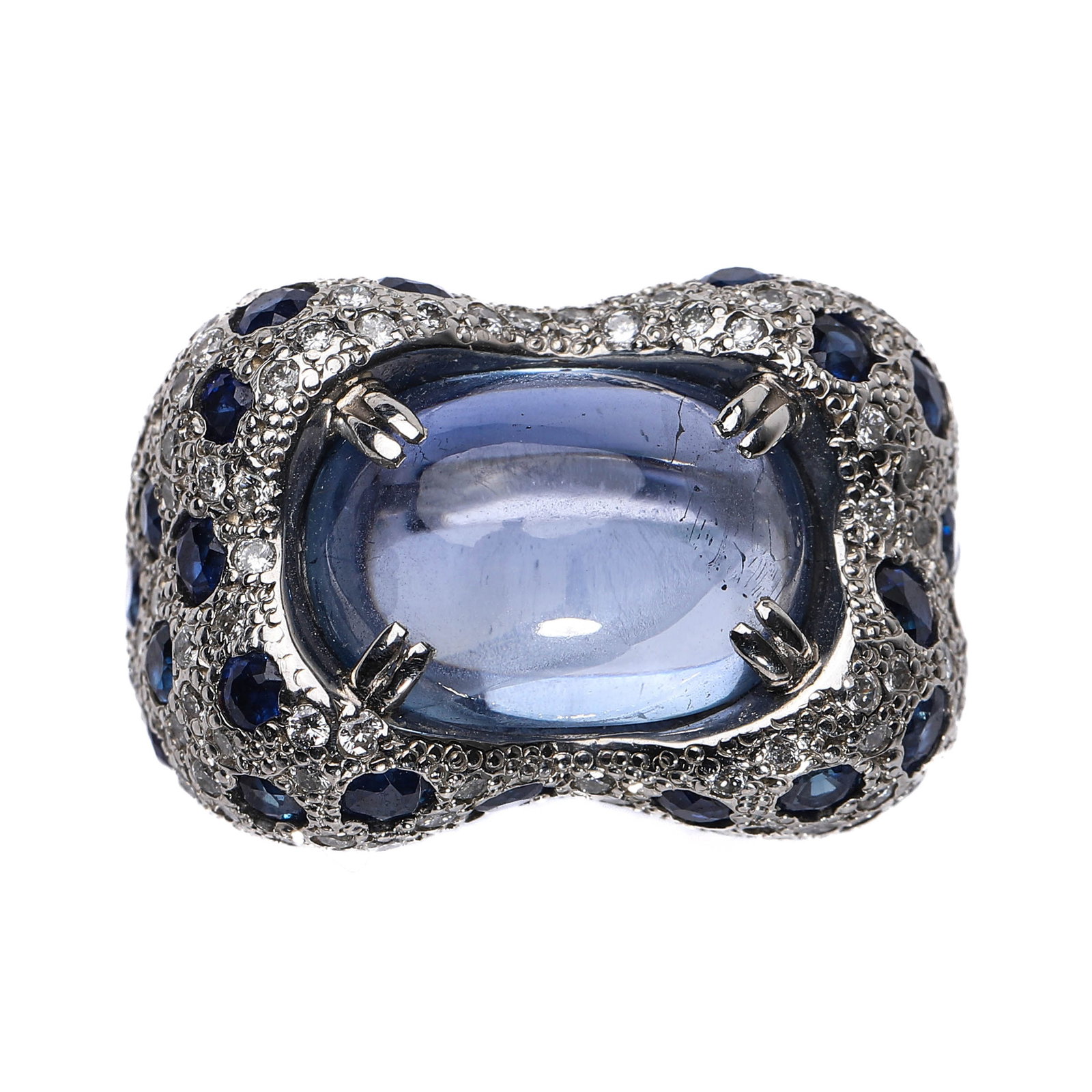 RETRO PERIOD SRI LANKAN UNHEATED BLUE SAPPHIRE RING: This magnificent ring showcases an impressive 11.92-carat Sri Lankan unheated cabochon blue sapphire, renowned for its flawless clarity and captivating brilliance. The substantial platinum setting is 