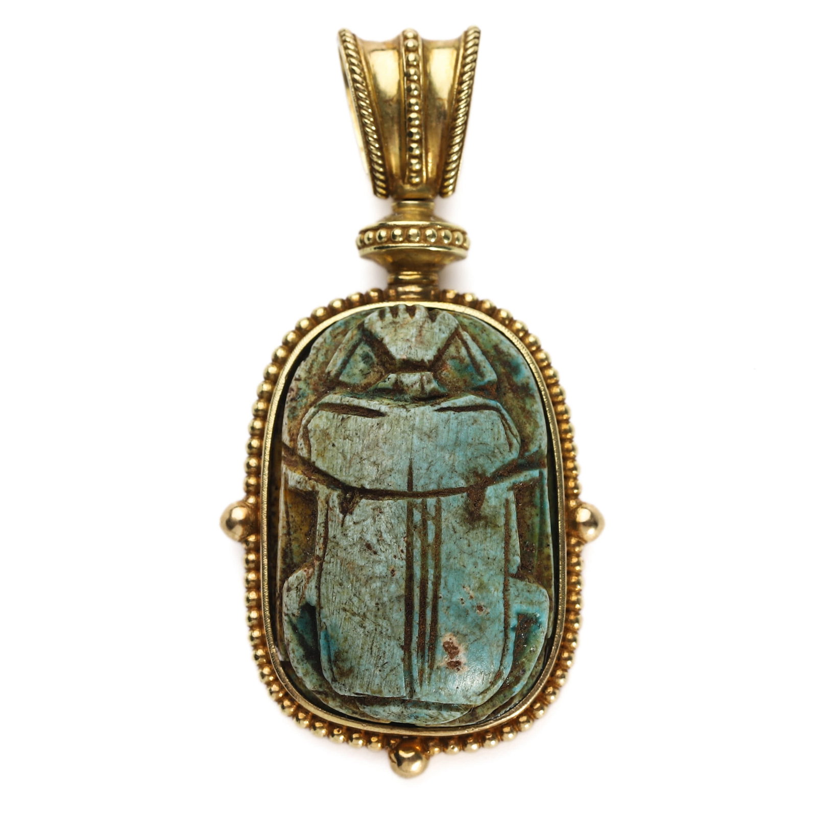 AN EGYPTIAN TURQUOISE SCARAB AMULET SET IN A MODERN GOLD PENDANT: Length: 2 1/8 in. (5.4 cm), Weight: 21.1 g This pendant features an ancient Egyptian scarab amulet carved from turquoise, symbolizing rebirth, transformation, and protection. The obverse depicts the