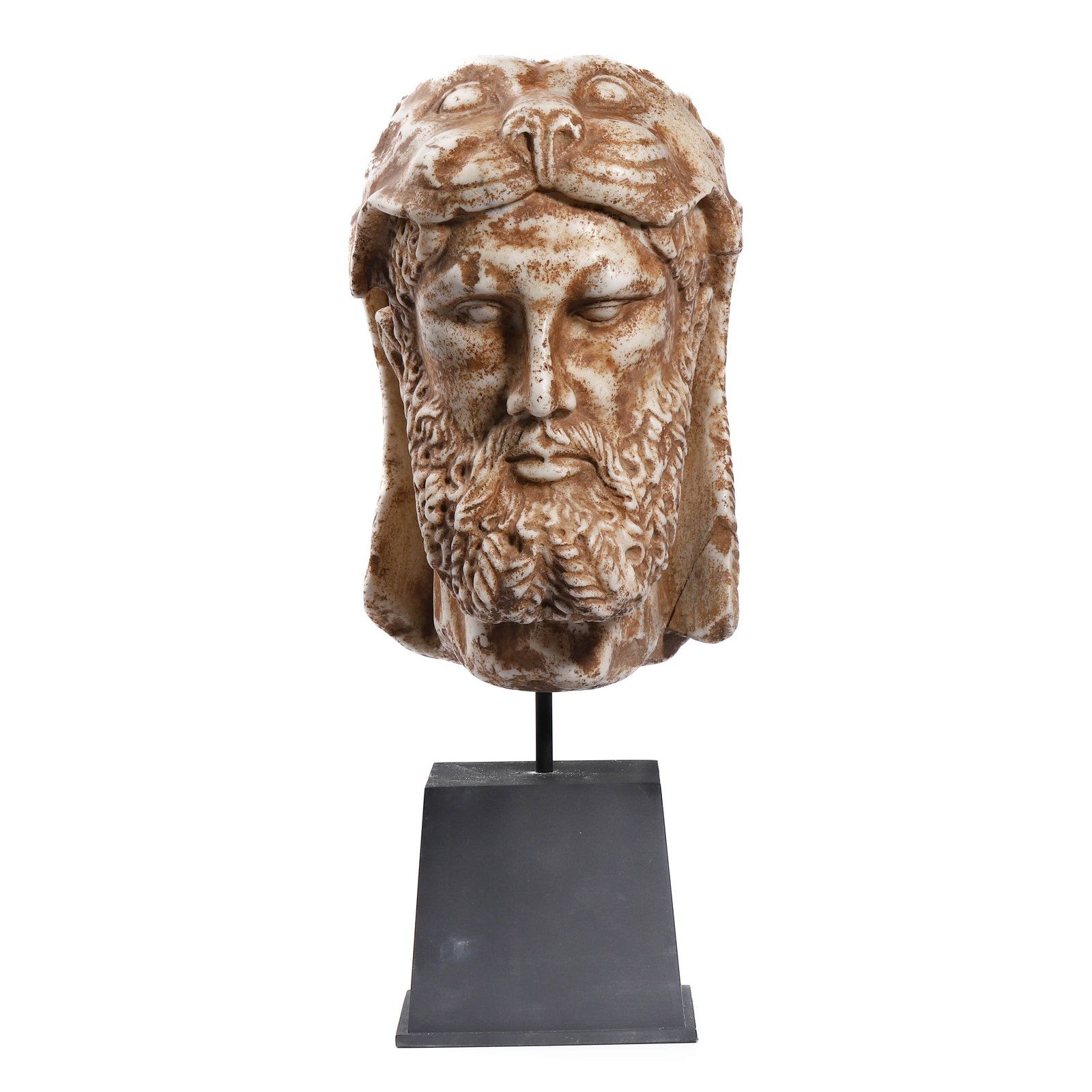 HEAD OF HERAKLES WEARING THE NEMEAN LION SKIN: Dimensions Height: 17 15/16 in (45.5 cm) Description A sculptural head depicting Herakles, shown wearing the iconic Nemean lion skin draped over the head and cascading along the sides and back. The be