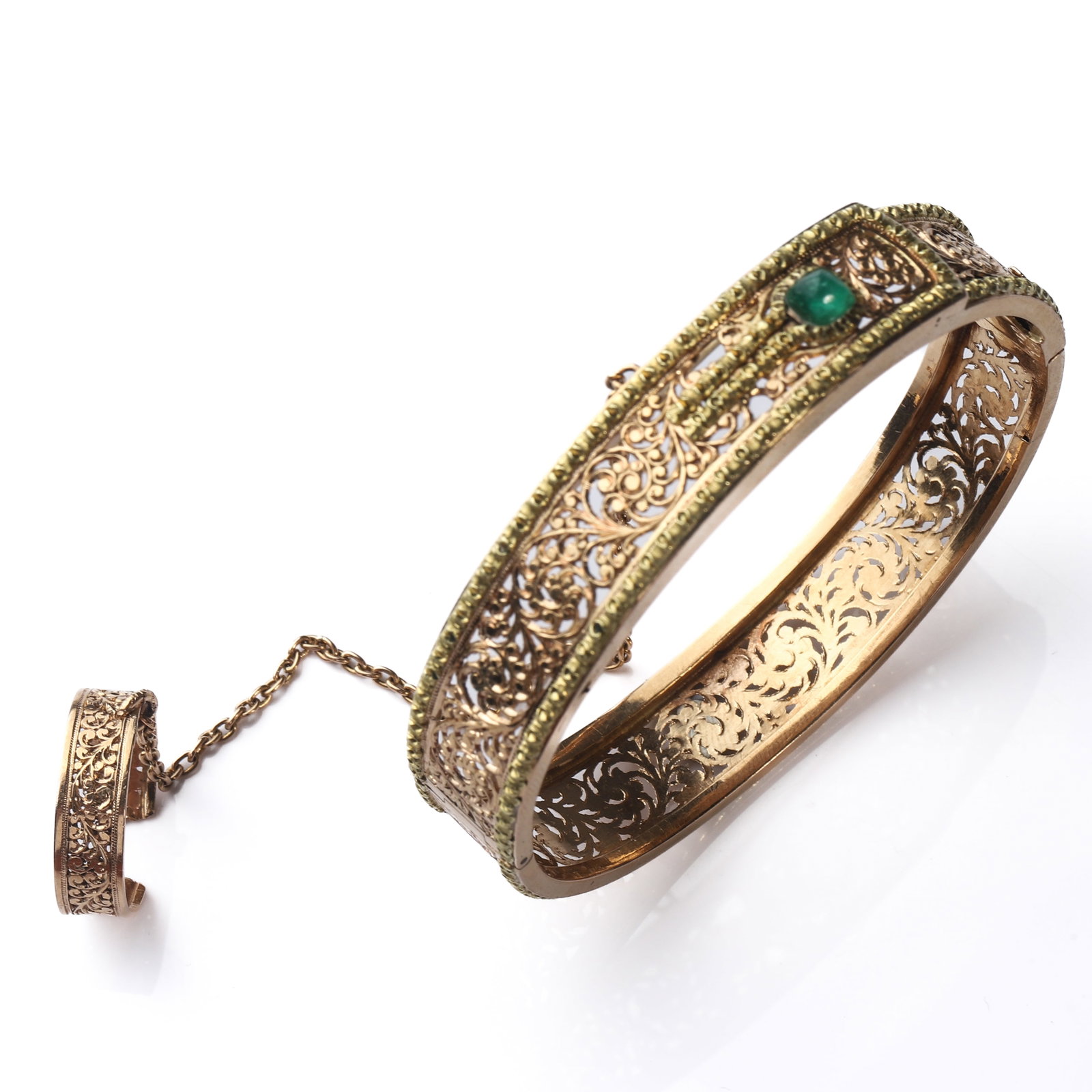 ANTIQUE GOLD FILIGREE, EMERALD AND HAND ORNAMENT BRACELET: Dimensions Inner Diameter 2 1/4in. (56.6 mm) Weight 23.8g Description An elaborate antique gold bracelet with an attached hand ornament, finely worked throughout with openwork filigree and scrolling f