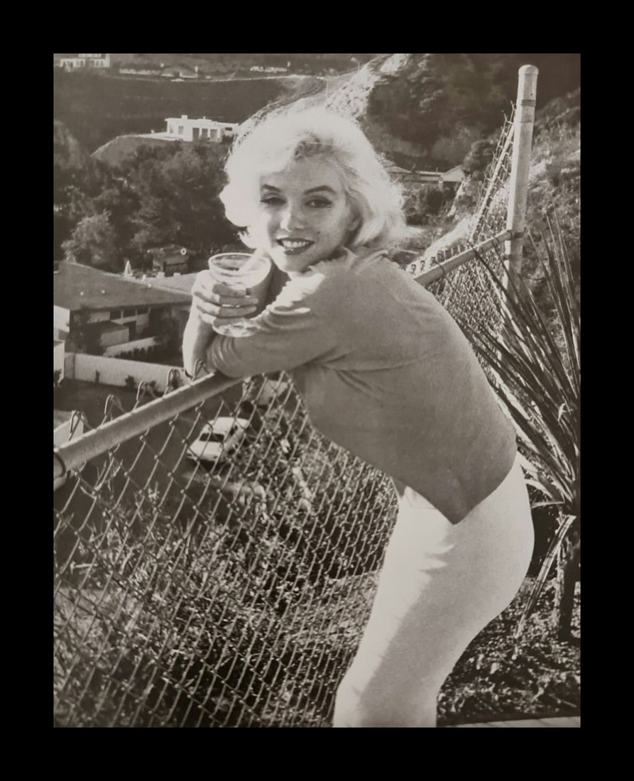 Marilyn Monroe enjoying a cocktail: Photographer: George Barris Subject/Title: Marilyn Monroe enjoying a cocktail Date Of Negative: Undated Type Of Print: Authentic Vintage Sheet Fed Photogravure/Heliogravure Date Of Print: 2000 Publish