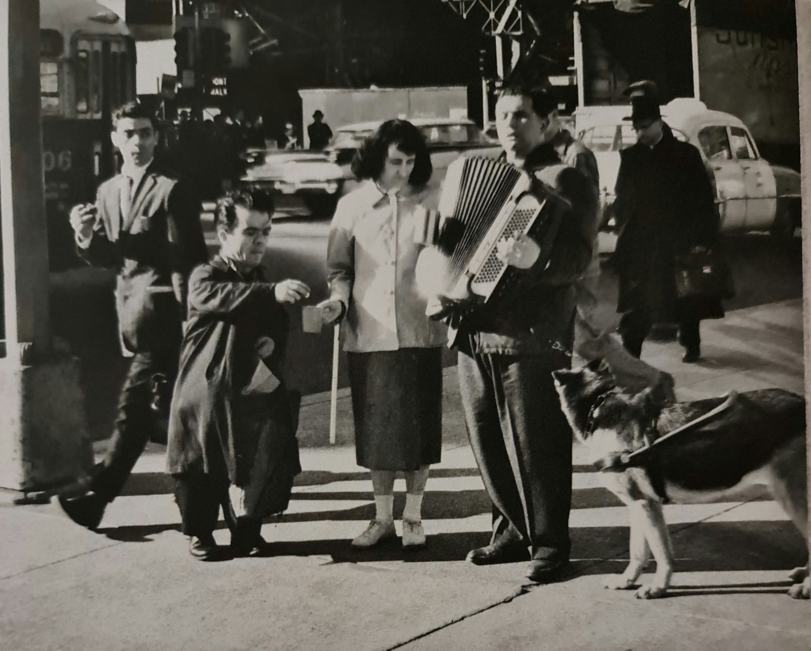 André Kertész, Acordian player, New York, 1959: Photographer: André Kertész, born Andor Kertész, was a Hungarian-born photographer known for his groundbreaking contributions to photographic composition and the photo essay. Subject: Acordian play