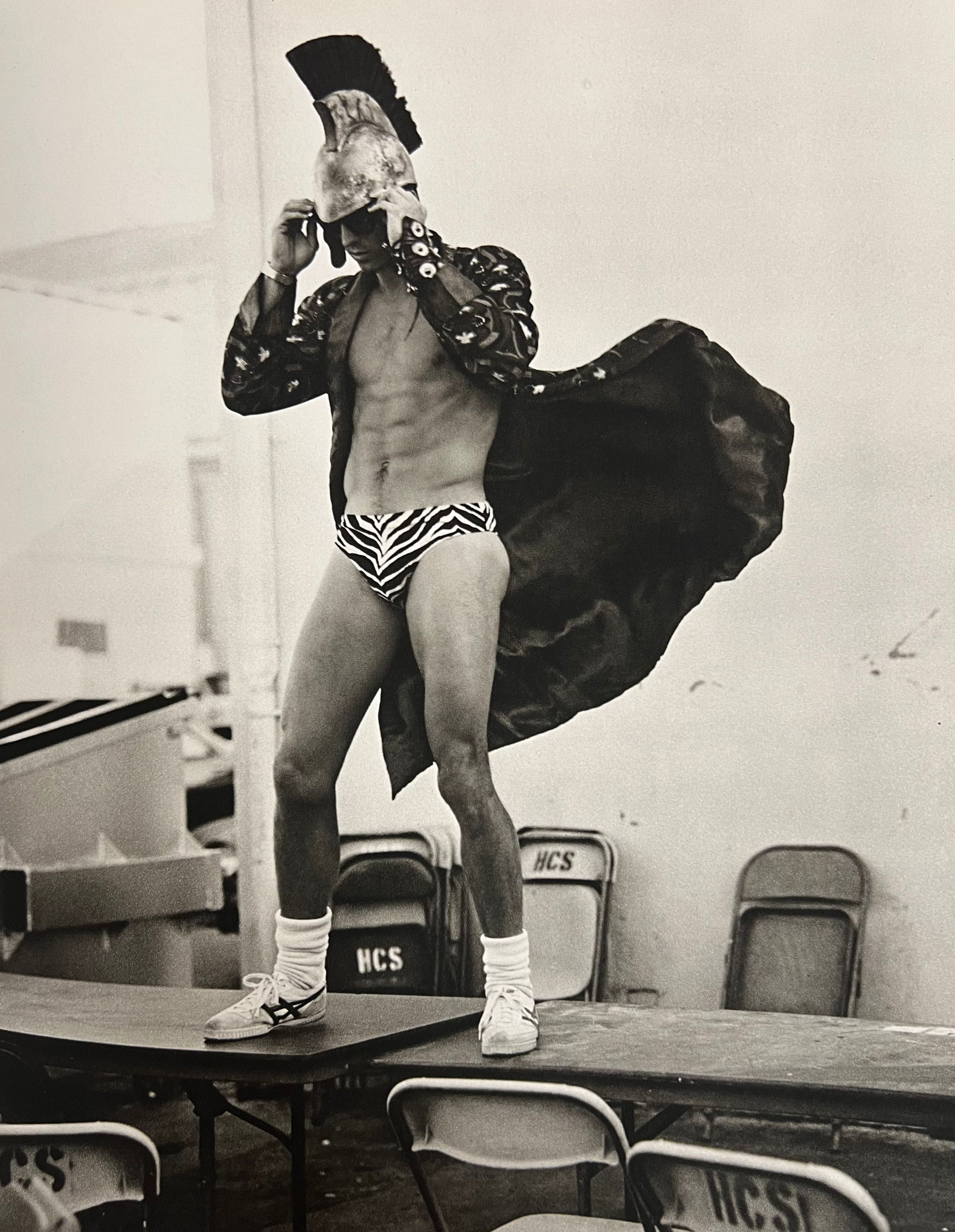 Bruce Weber, Man in speedo standing on tables, 1988: Photographer: Bruce Weber (American, b. 1946) - internationally renowned American fashion photographer best known for his racy, erotically charged imagery. Weber has shot the ad campaigns of Calvin Kl