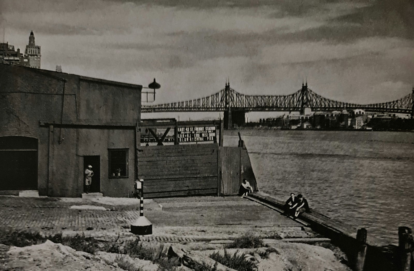 André Kertész, East 43rd St Freight Station, New York, 1938: Photographer: André Kertész, born Andor Kertész, was a Hungarian-born photographer known for his groundbreaking contributions to photographic composition and the photo essay. Subject: East 43rd St