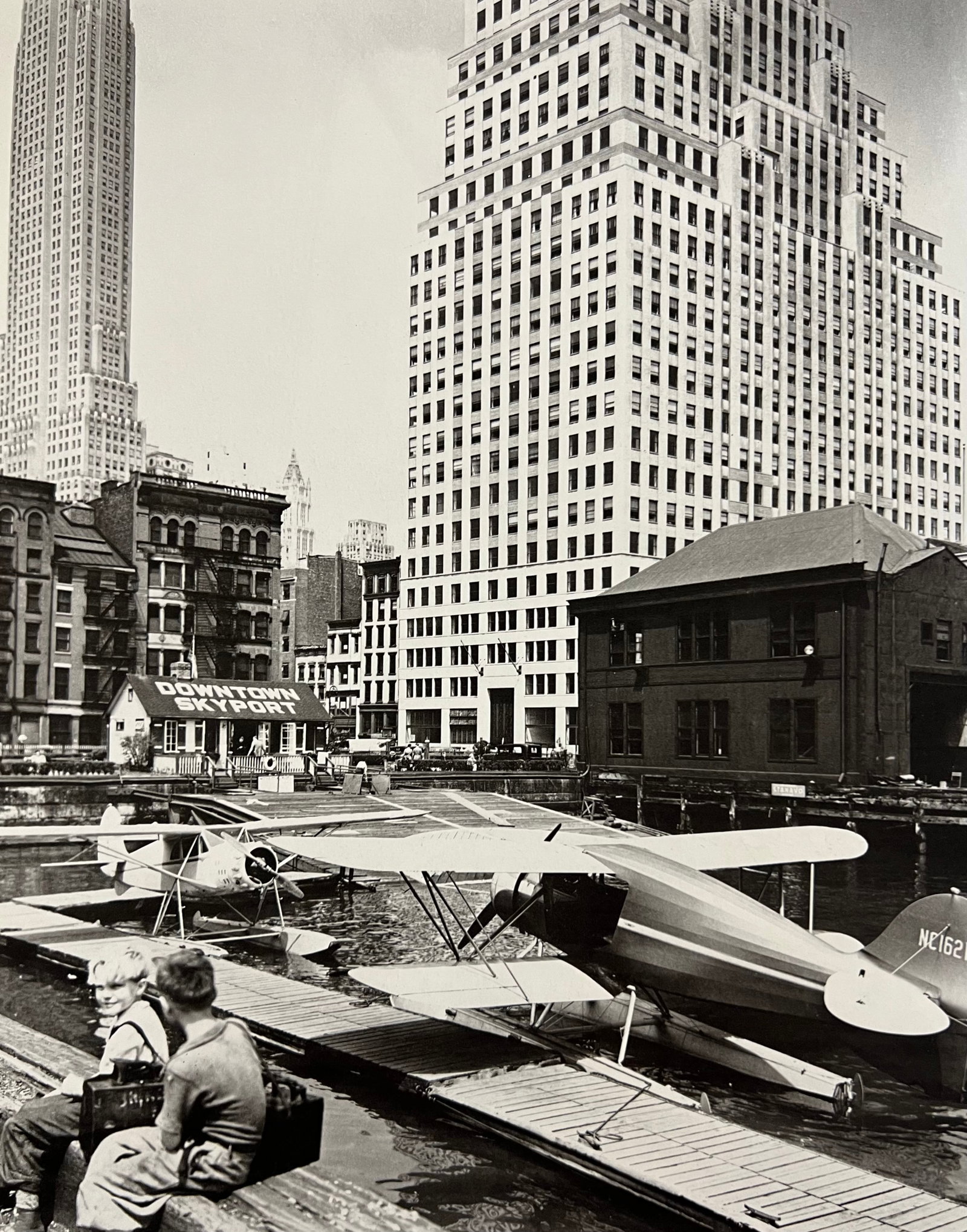 Berenice Abbott, Downtown Skyport, Foot Of Wall Street, 1930s: Photographer: Berenice Alice Abbott was an American photographer best known for her portraits of between-the-wars 20th century cultural figures, New York City photographs of architecture and urban des