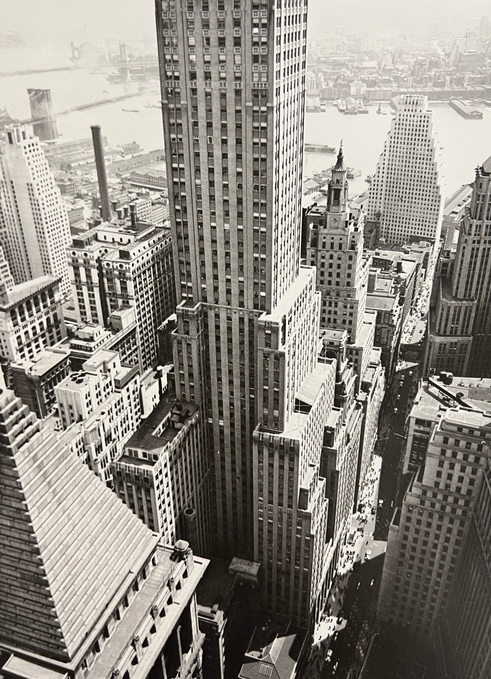 Berenice Abbott, Wall Street Showing East Riover, 1930s: Photographer: Berenice Alice Abbott was an American photographer best known for her portraits of between-the-wars 20th century cultural figures, New York City photographs of architecture and urban