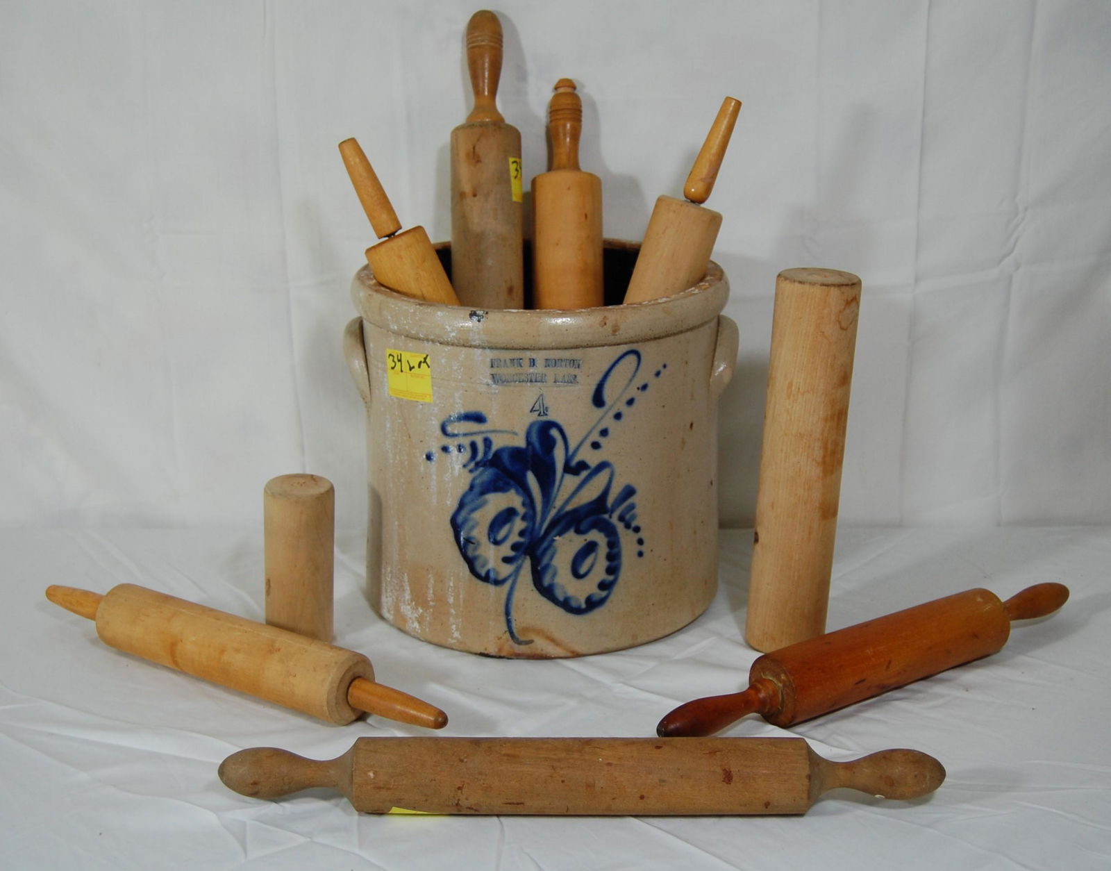 Vintage F.B. Norton Crock & Vintage Rolling Pins: Frank B. Norton Worcester MA Four Gallon Crock and Large Lot of Vintage Rolling Pins. Crock is hand painted floral design with no lid and is in well-used condition. Also - 14 wood rolling pins includi