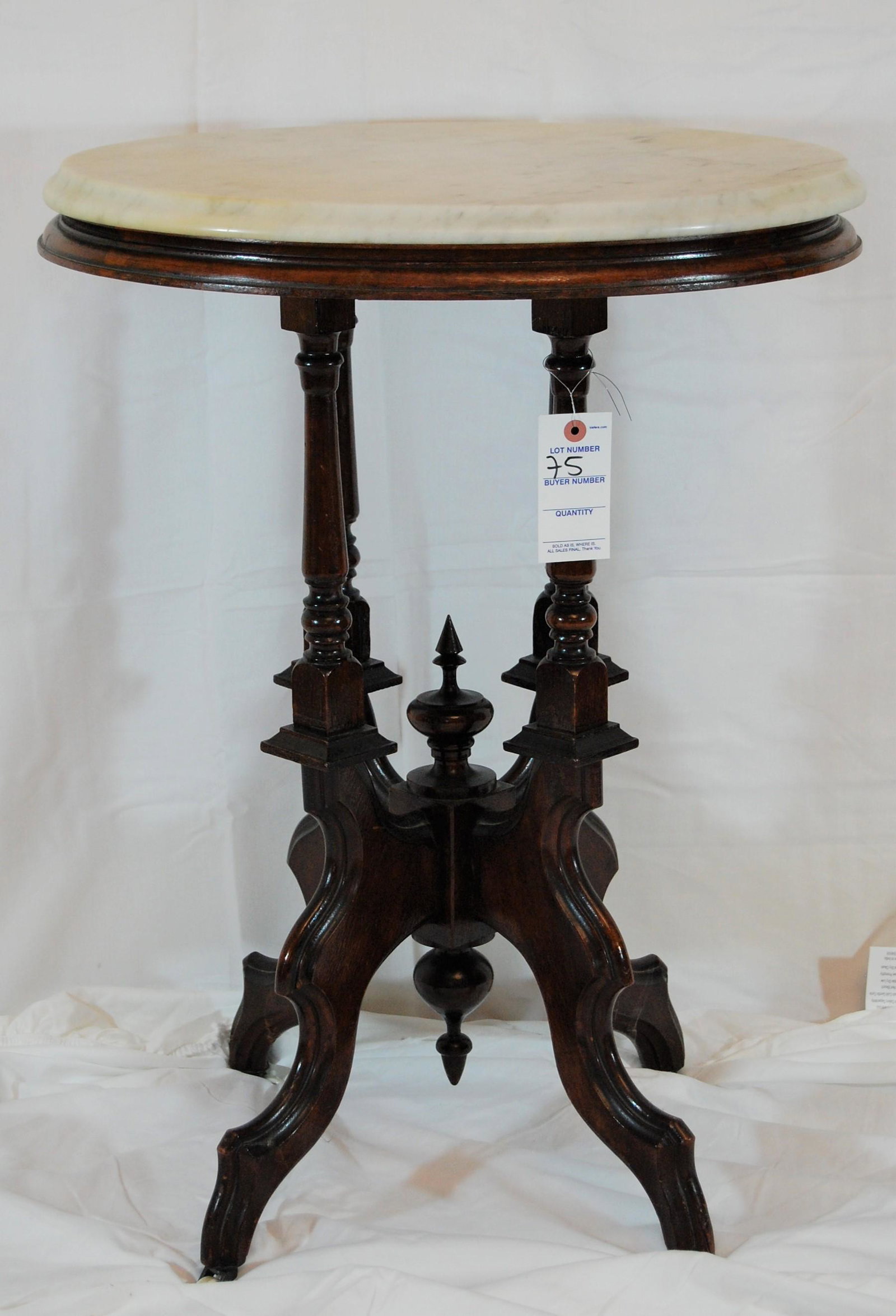 Victorian Marble Top Mahogany Table: Victorian Marble Top Mahogany Table. The top rests on 4 turned supports, legs on casters. 29"h x 17"d x 21"w.
