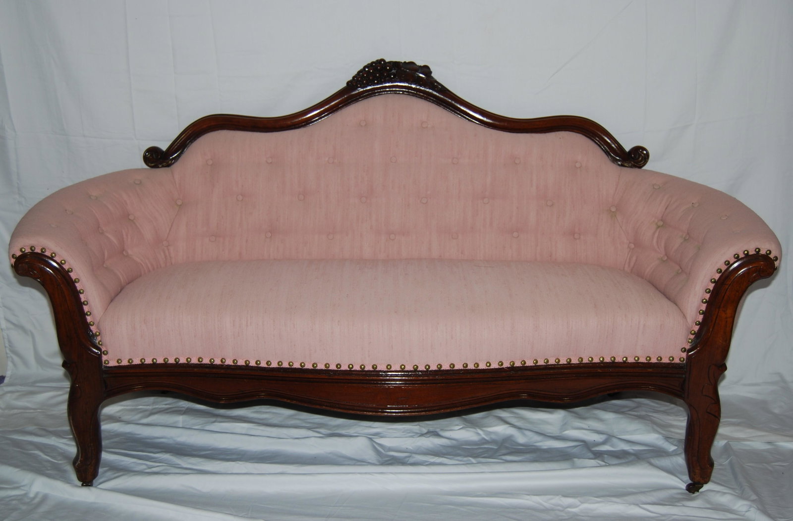 Antique Century Camel Back Settee-1800s: 1800's Century Camel Back Settee. Original brass and wood casters. Mauve colored fabric. Nice condition. From 1860-80. 34"h x 64"w x 27"d.