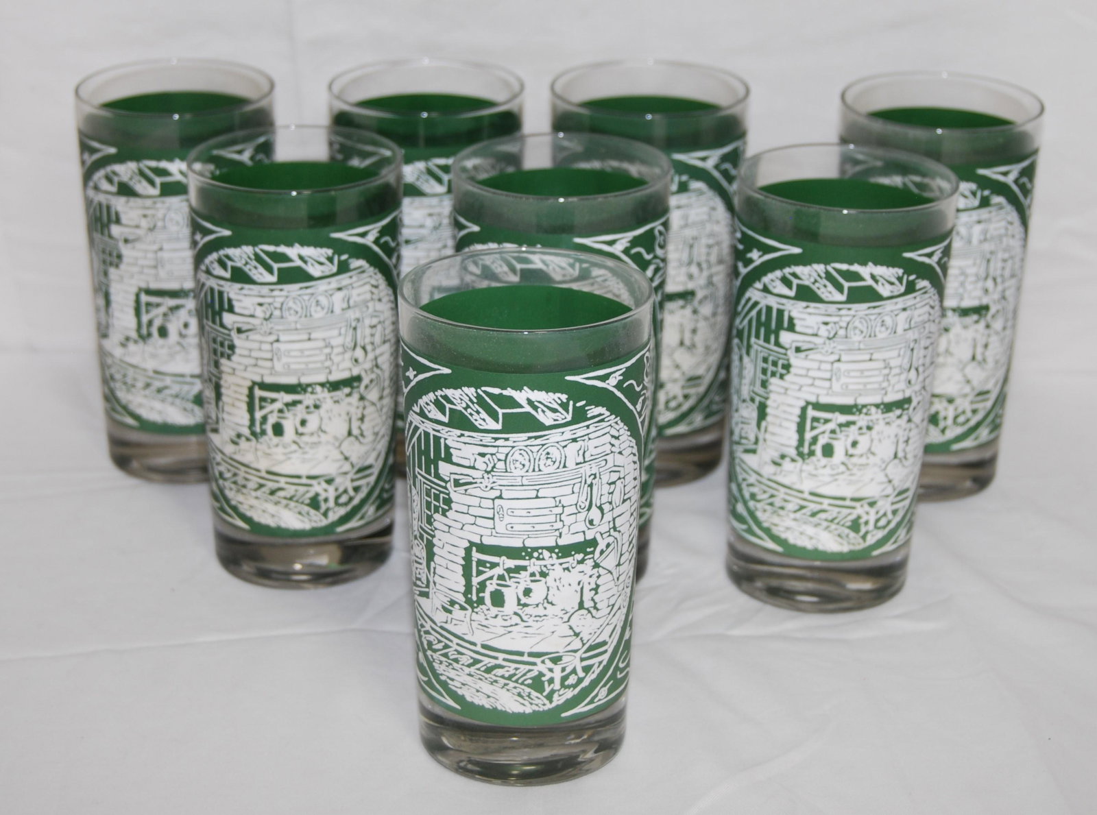 Vintage Old Curiosity Green Tumblers-12 oz: Vintage Old Curiosity Green Tumblers. This is a lot of eight tumblers in the Old Curiosity green. 12 oz. Depict fireplace scene.