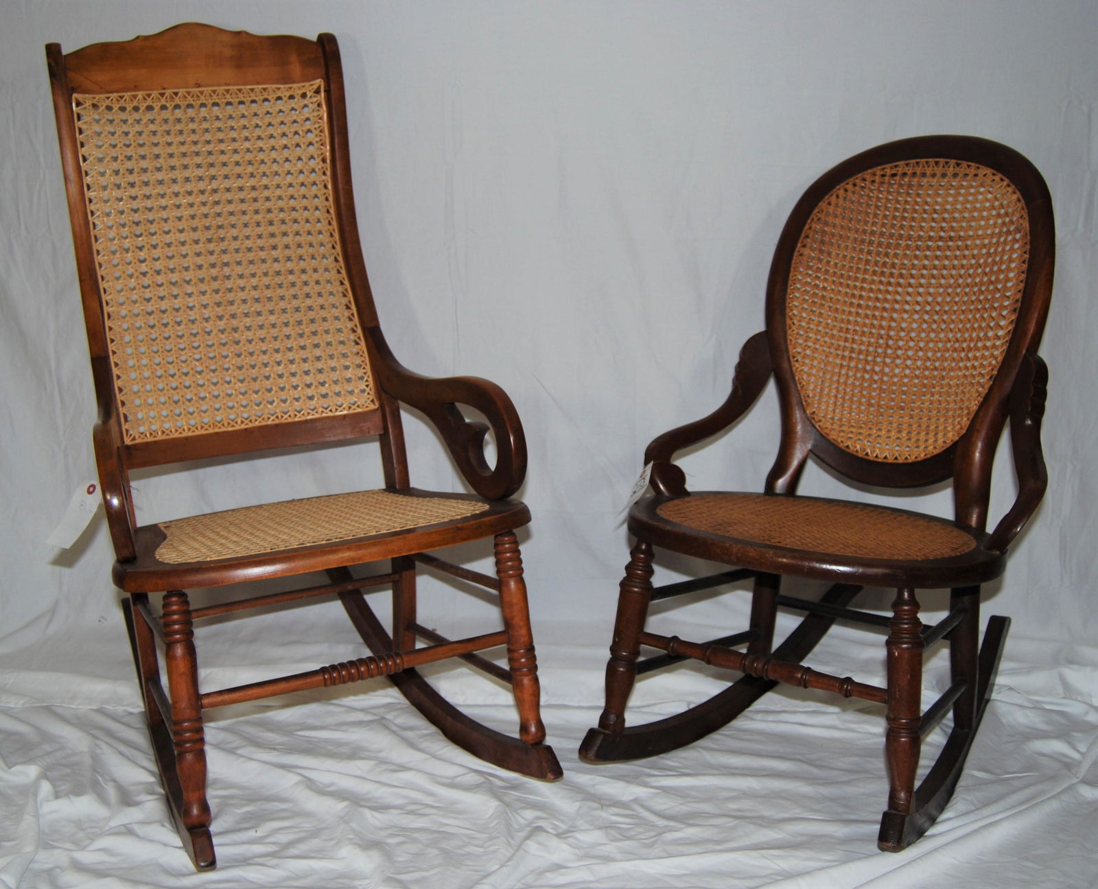 Two - Vintage Rocking Chairs: Two - Vintage Rocking Chairs. Chairs appear refinished & cane seats have replaced are in like-new condition. One is 40"h. One is 33"h.