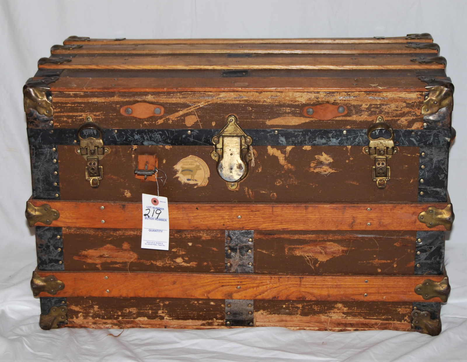 19th Century Travel Trunk: 19th Century Travel Trunk. Exterior is canvas covered with tin corners and wood bands, leather handles, tin bottom. Interior has original paper lining. This trunk shows wear from travel and a travel l
