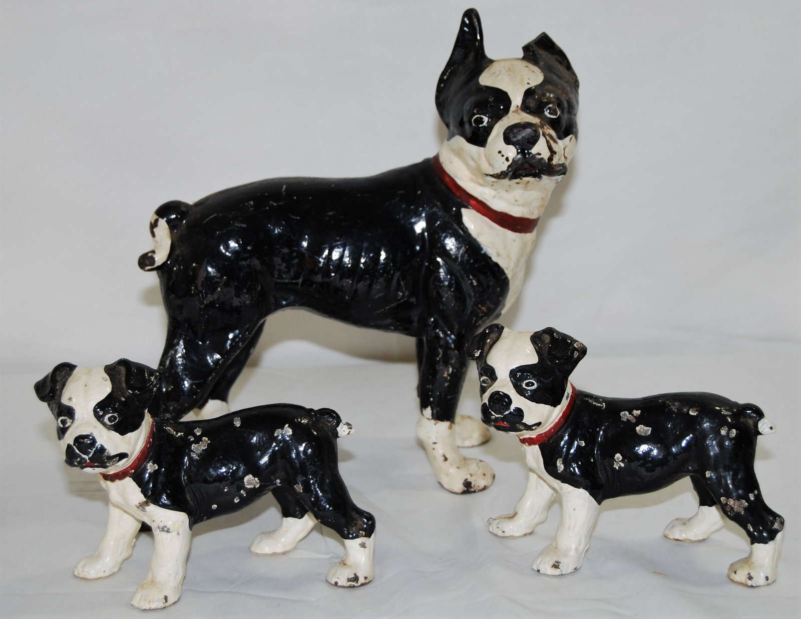 3 - Hubley Cast Iron Boston Terrier Door Stops: Hubley Cast Iron Boston Terrier Door Stops, original paint. Lot of 3 dogs, one full grown & 2 puppies. Mom’s left ear is broken, she’s 10” tall & 10” long. The 2 puppies are 4&