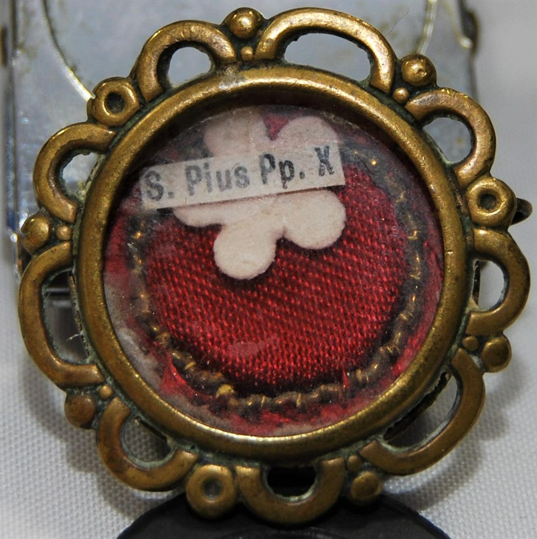 Reliquary-Pope Saint Pius X-Holy Relic Pendant: Reliquary – Pope Saint Pius X, Holy Relic Pendant & Vatican Souvenir 1950 Coin & Stamp Booklet. The relic is of Saint Pope Pius X (1835-1914) Canonized Vatican Pope - he was the 257th Pontiff of