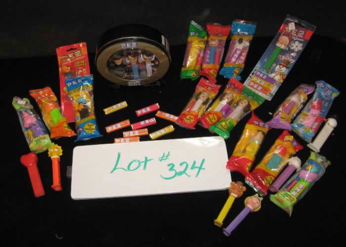 Pez Collection: Pez Collection includes (1) Elvis collectible tin with three dispensers & CD, Charlie Brown, Snoopy, Woodstock, Fred Flintstone & Pebbles, (3) Princess Leia, (2) Daffy Duck, Fozzy Bear, Ms. Piggy, Lis