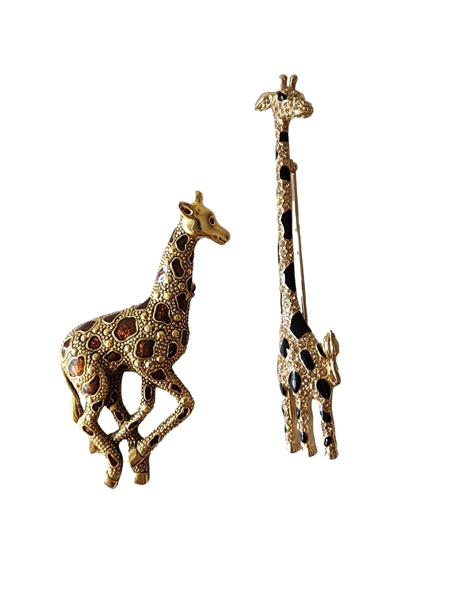 2 Giraffe Pins. Both Stamped, The tall one: Carolee- Limited edition. The shorter one KC (possibly: Tall one - 4 1/4". One Black with crystal stone and the other features Brown enamal spots.